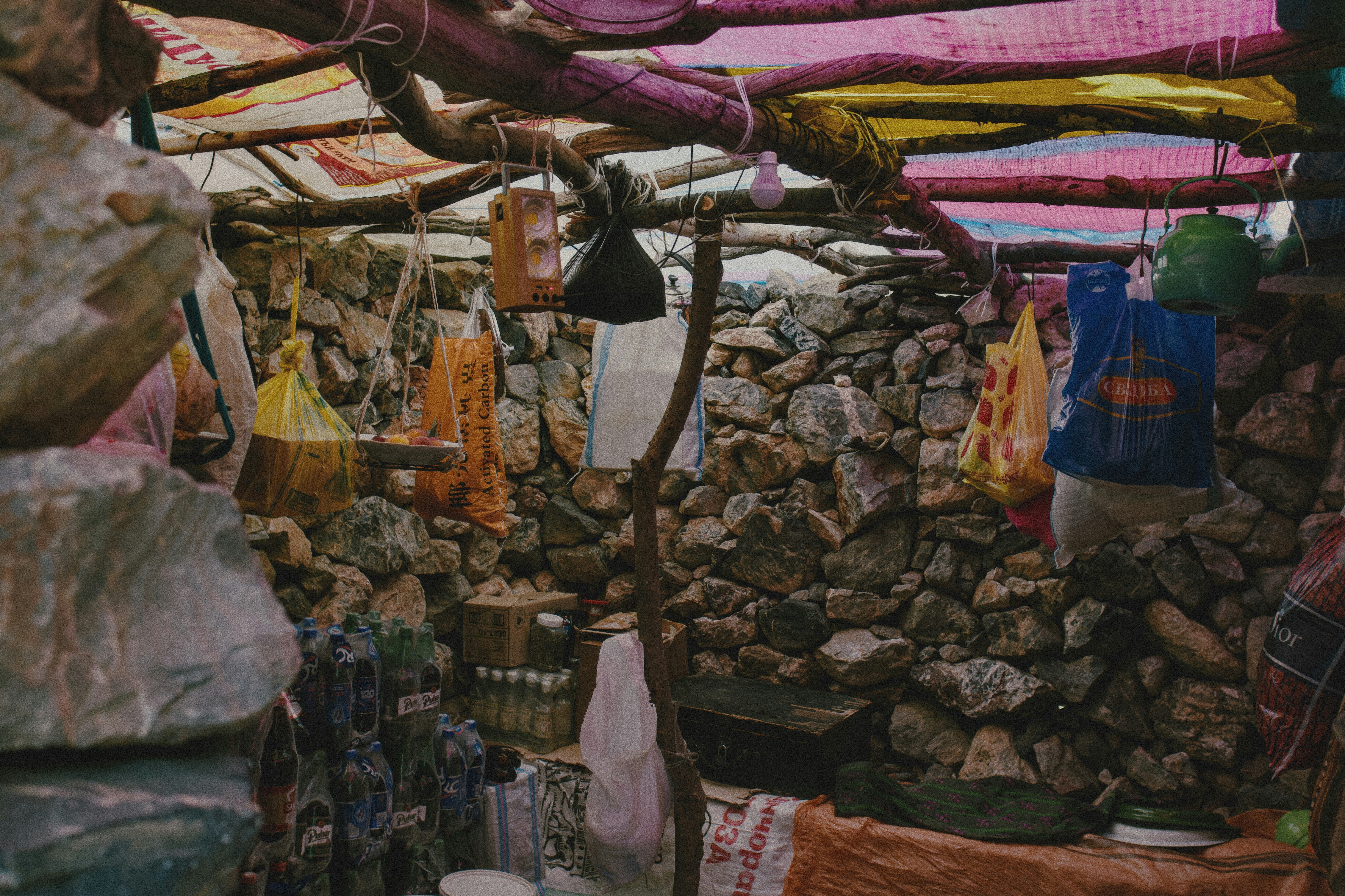 Rustic stone shelter with tarp roof - Free Photo on Unsplash