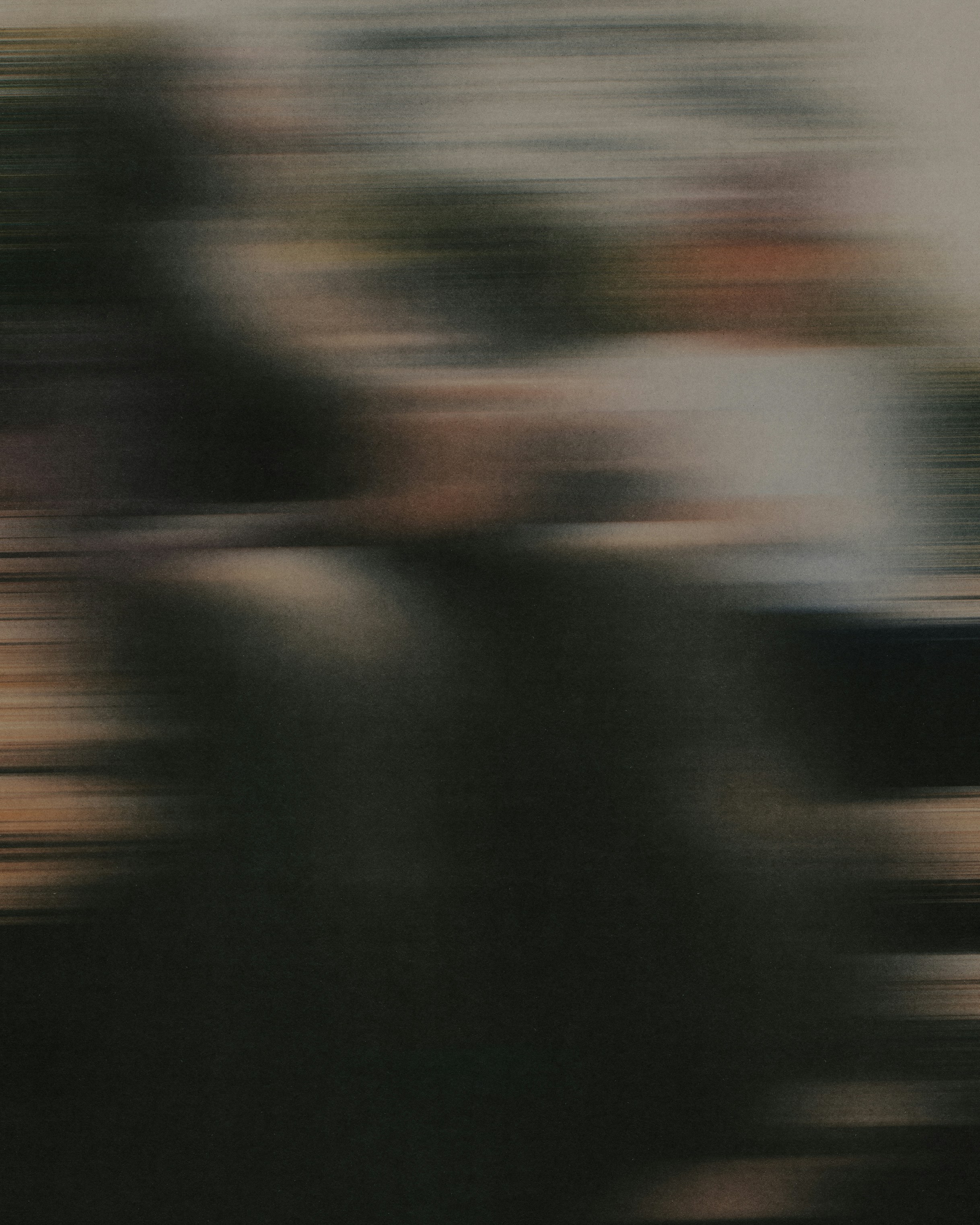 Abstract motion blur with horizontal streaks of dark grey and muted earth tones