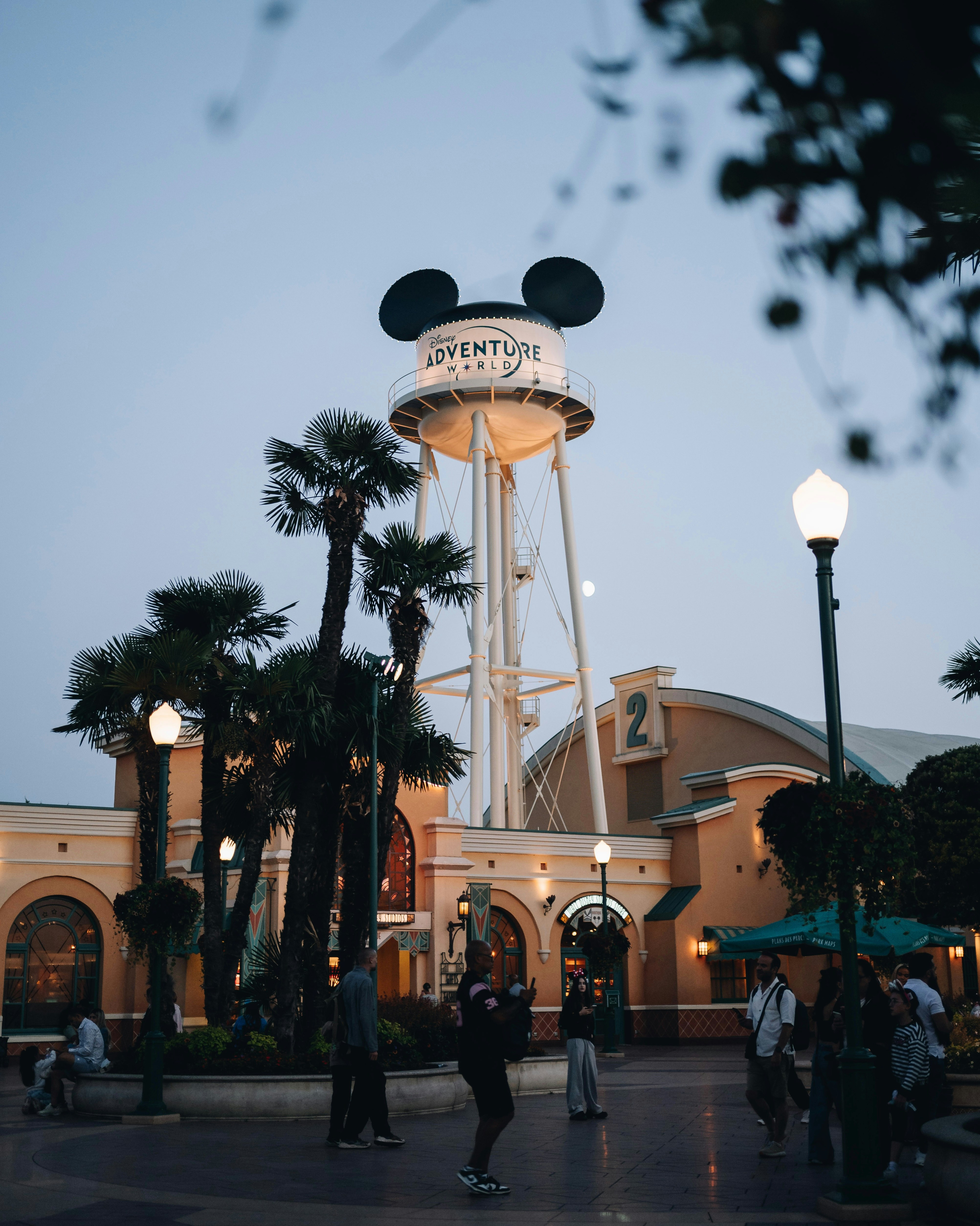 The Disney Adventure World water tower with Mickey ears above a theme park plaza
