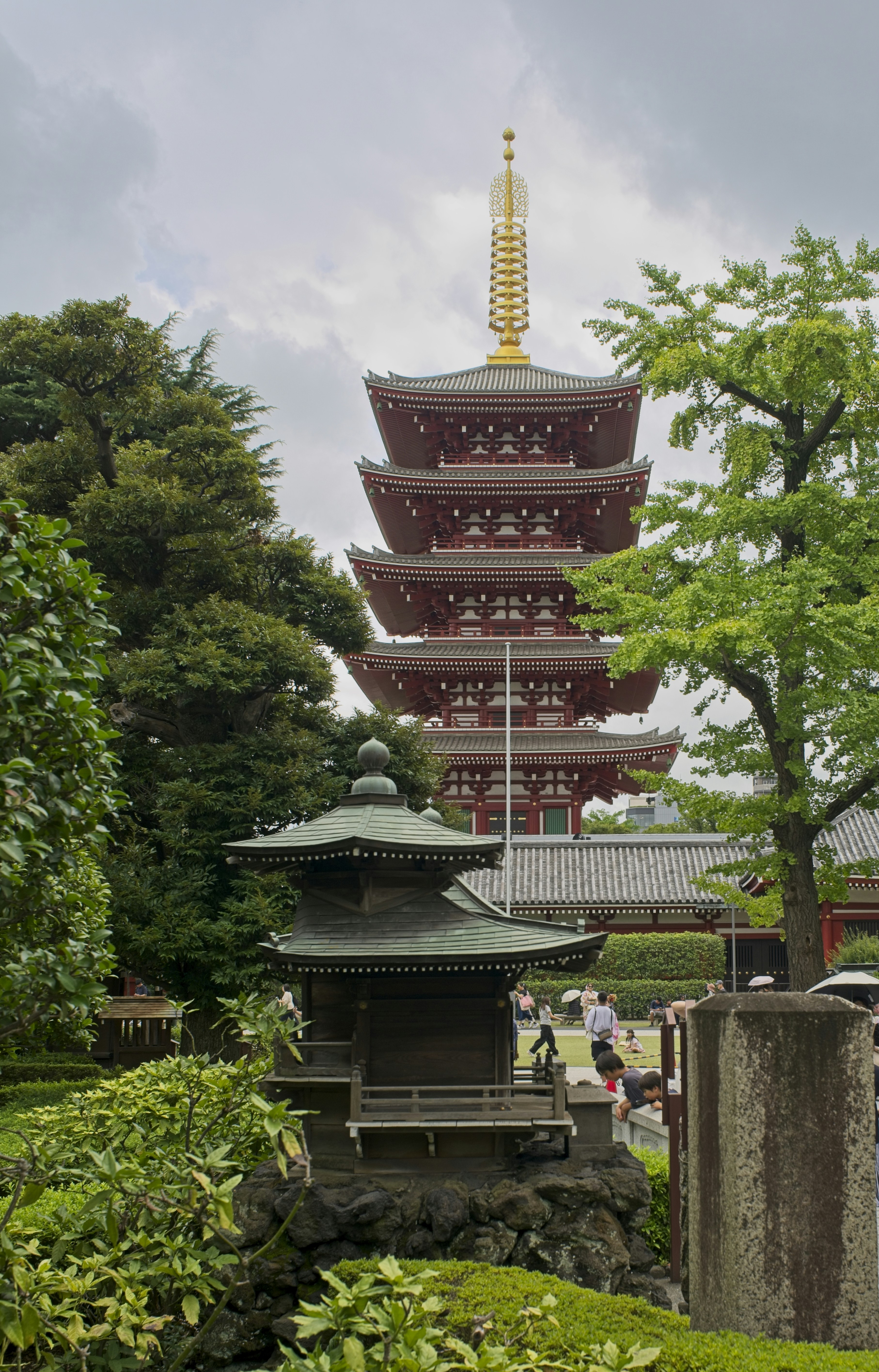 A red five-story pagoda with a gold spire in Senso-ji temple, Tokyo