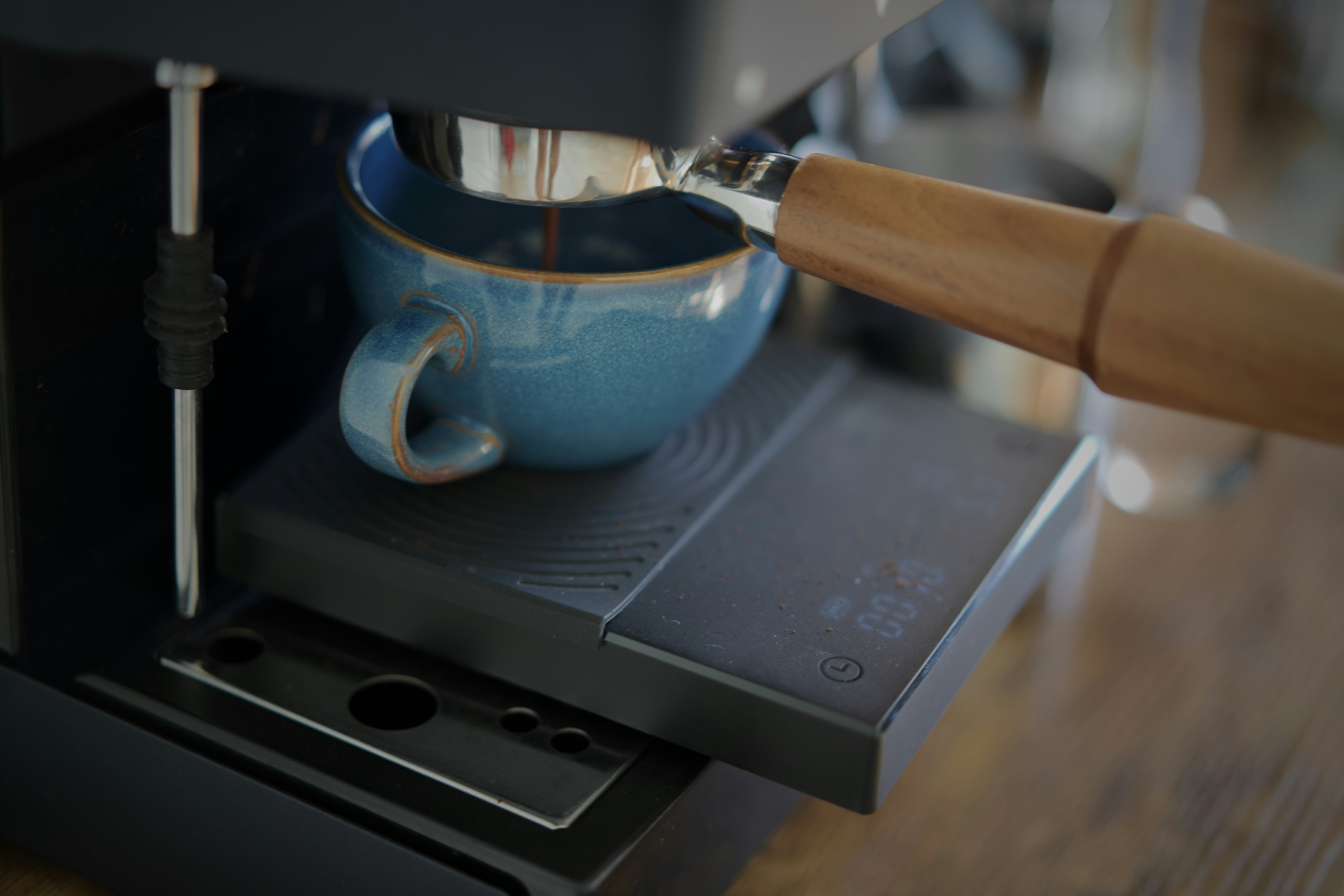 Espresso pouring into a blue cup