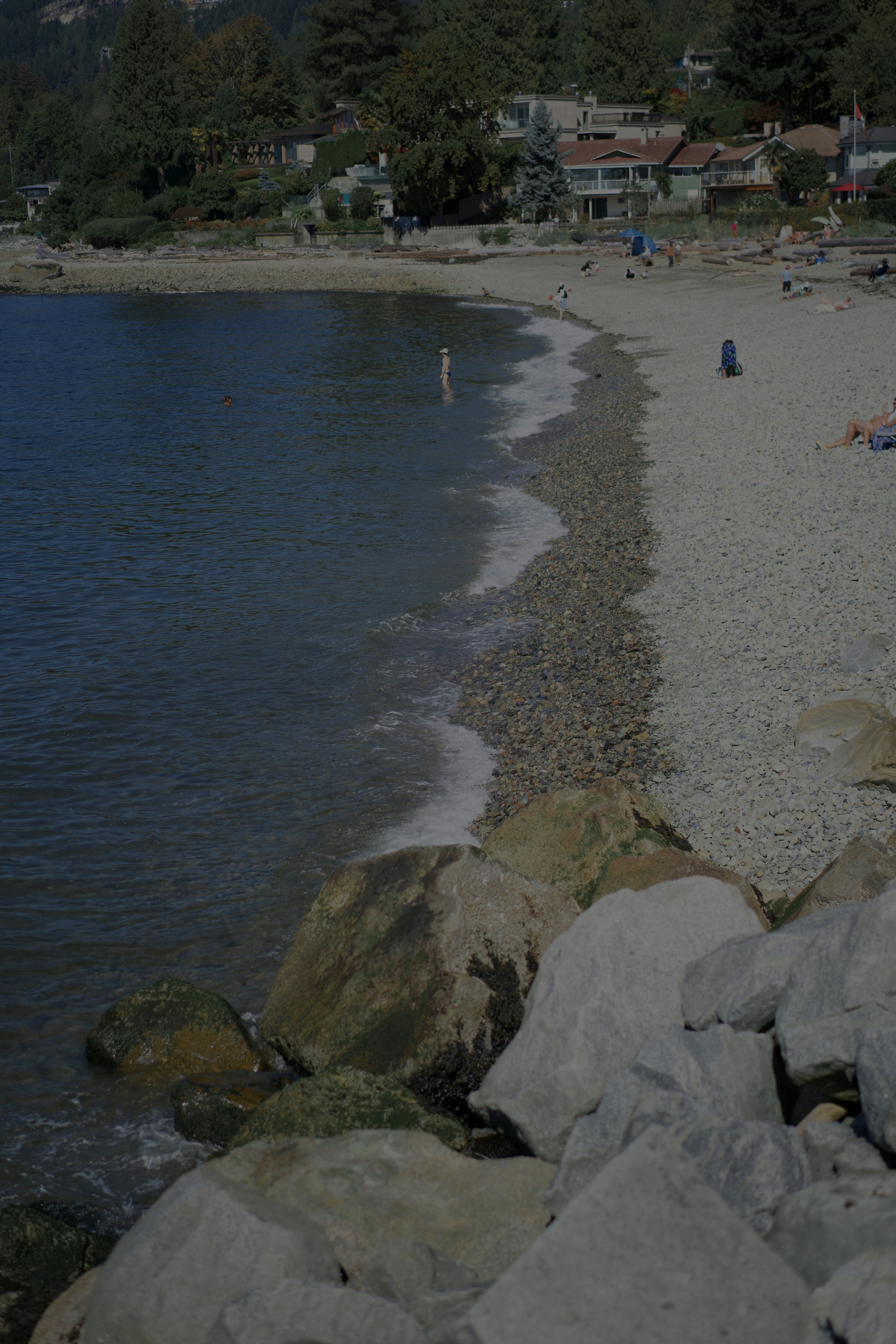 A small beach curving along the Ambleside waterfront.