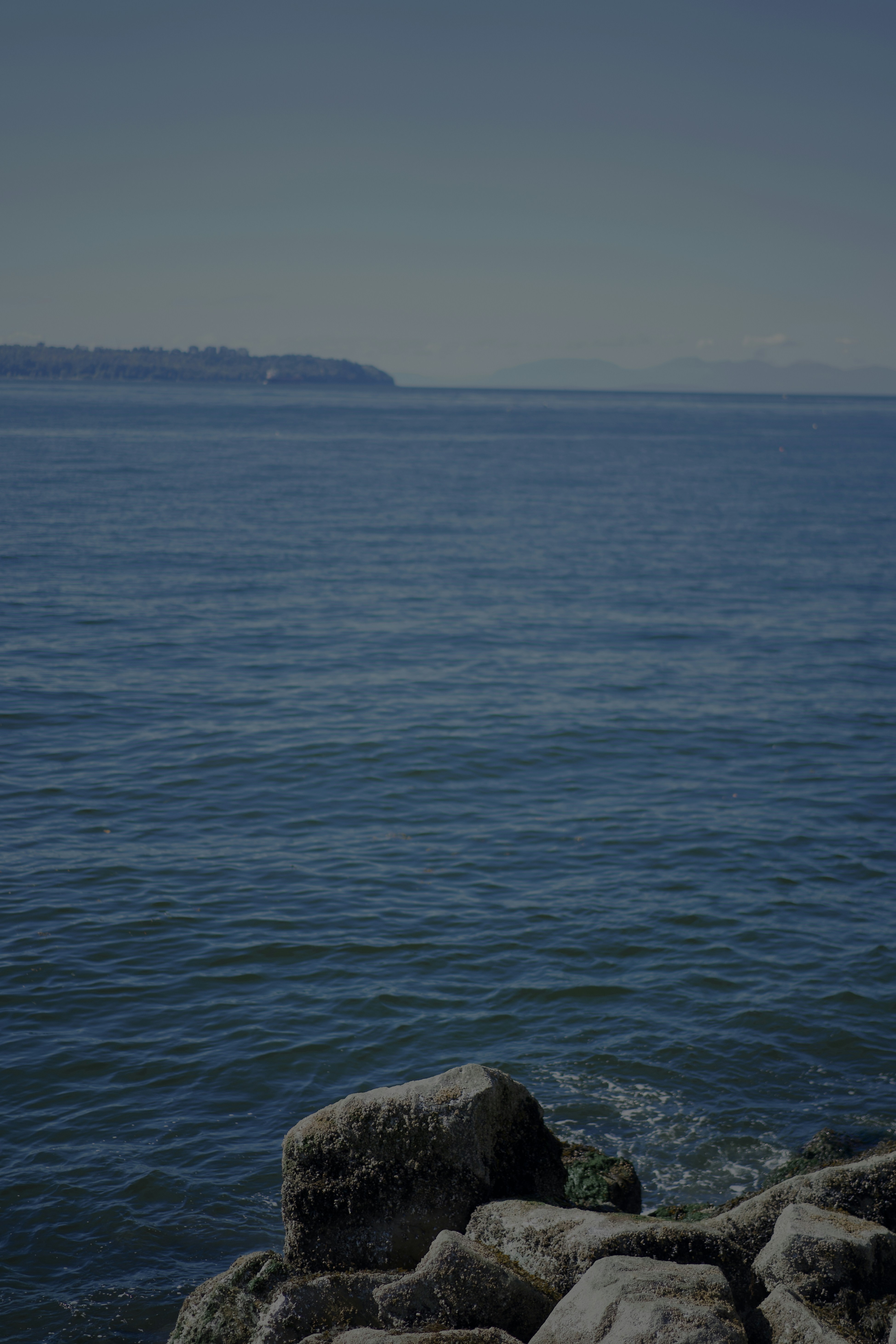 A calm coastal view from the Ambleside waterfront in West Vancouver.