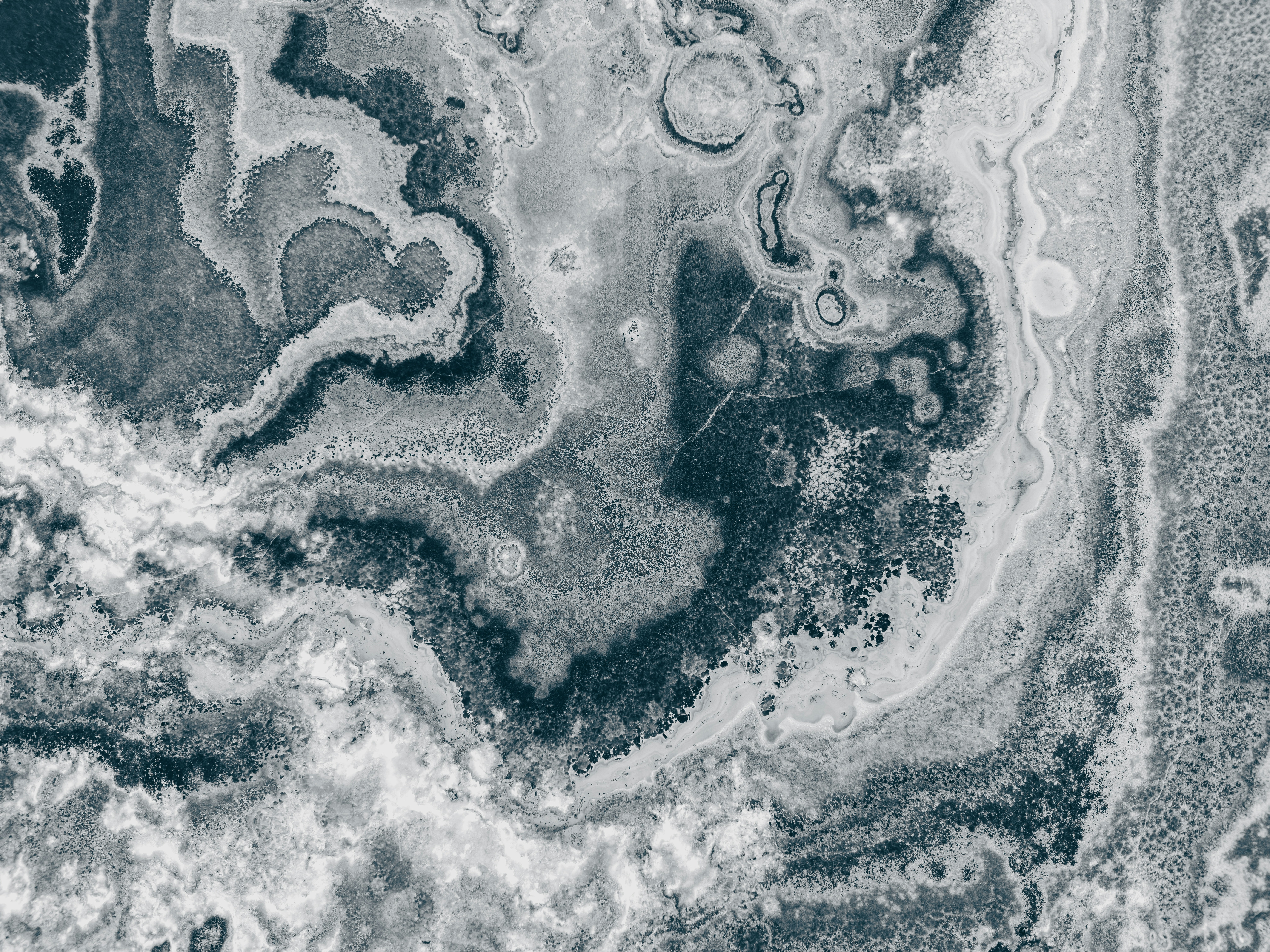 A swirling pattern of dark blue and white marble stone texture
