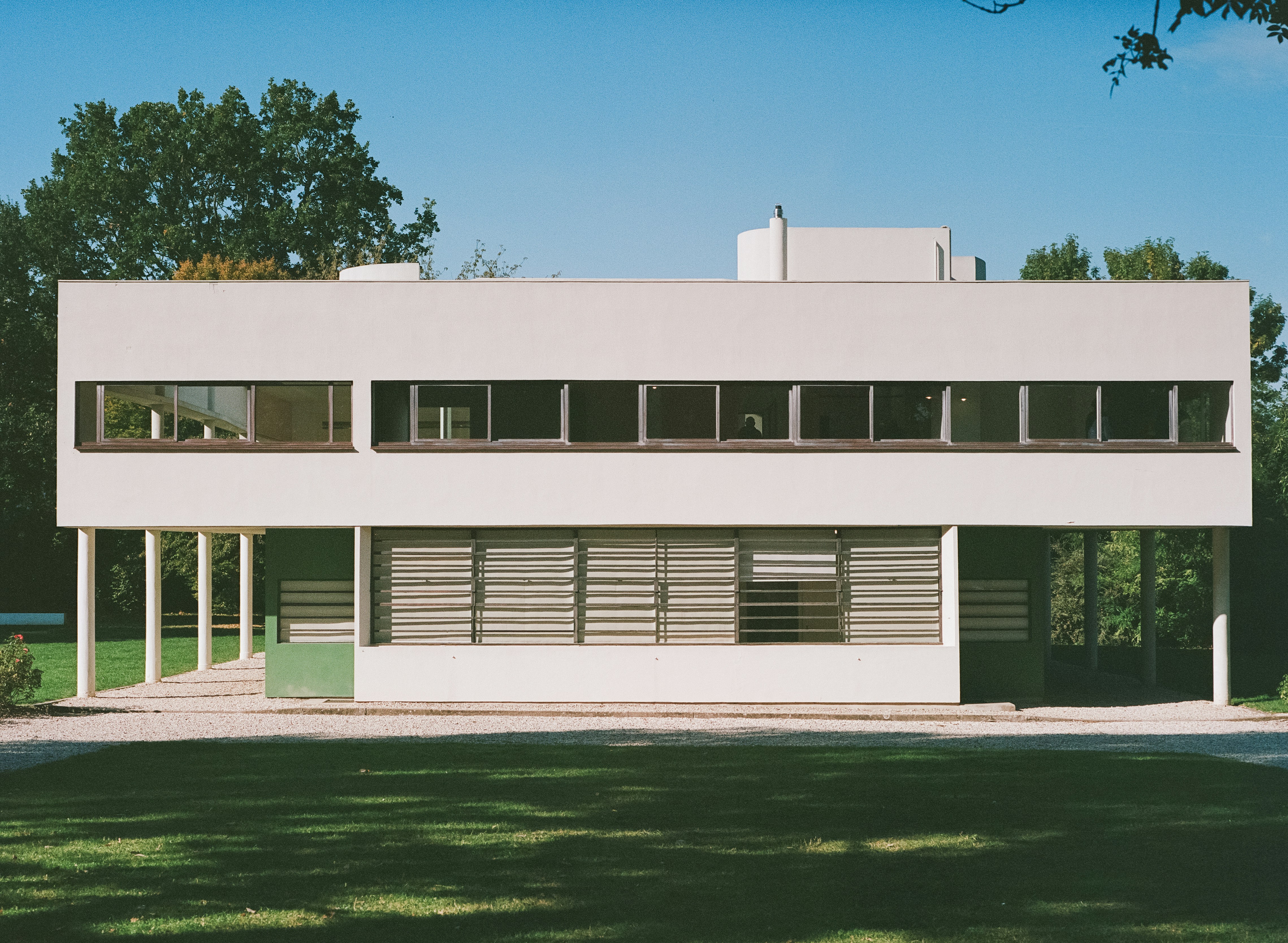 film actor standing in sleek minimalist concrete glass villa
