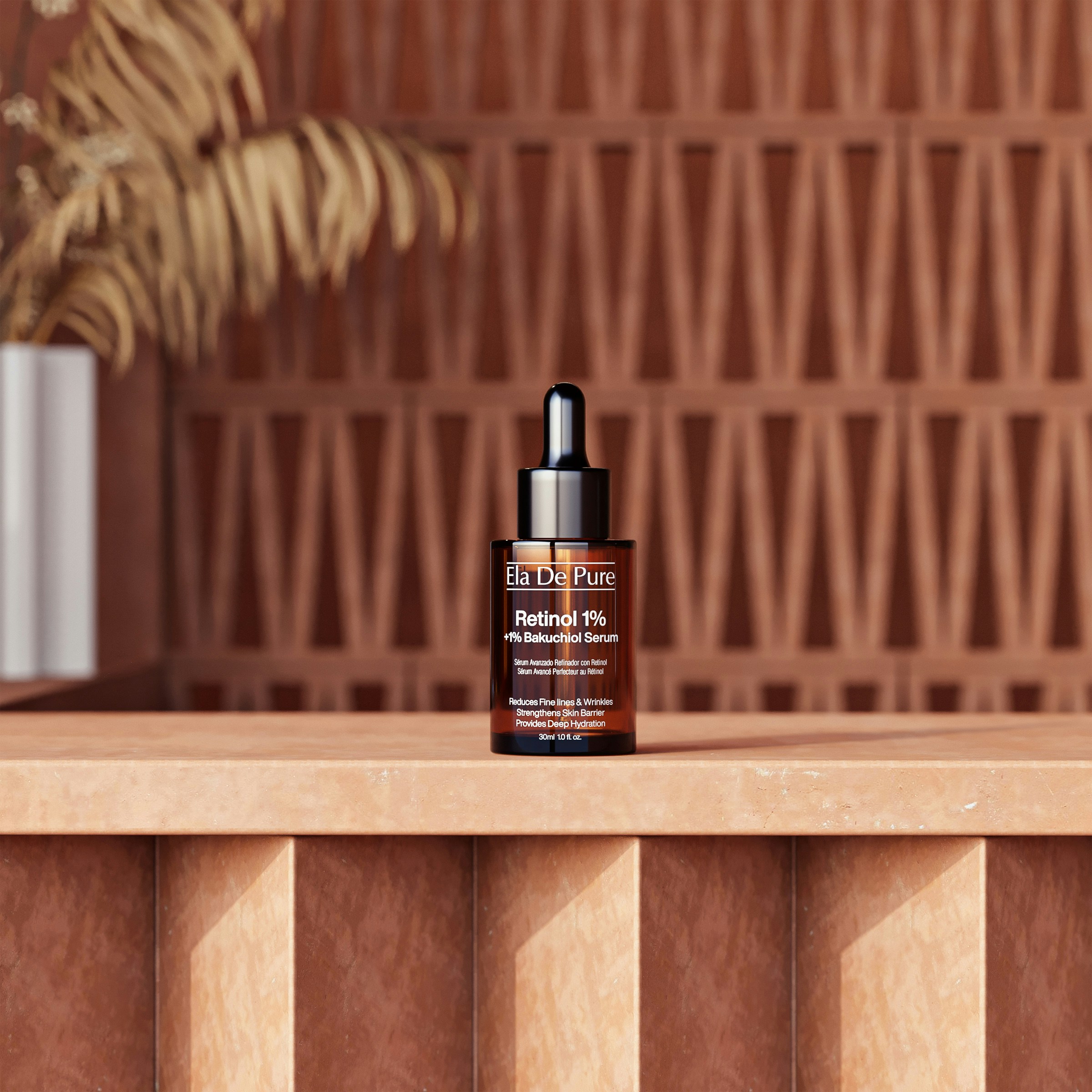 A brown glass dropper bottle of serum on a textured terracotta surface