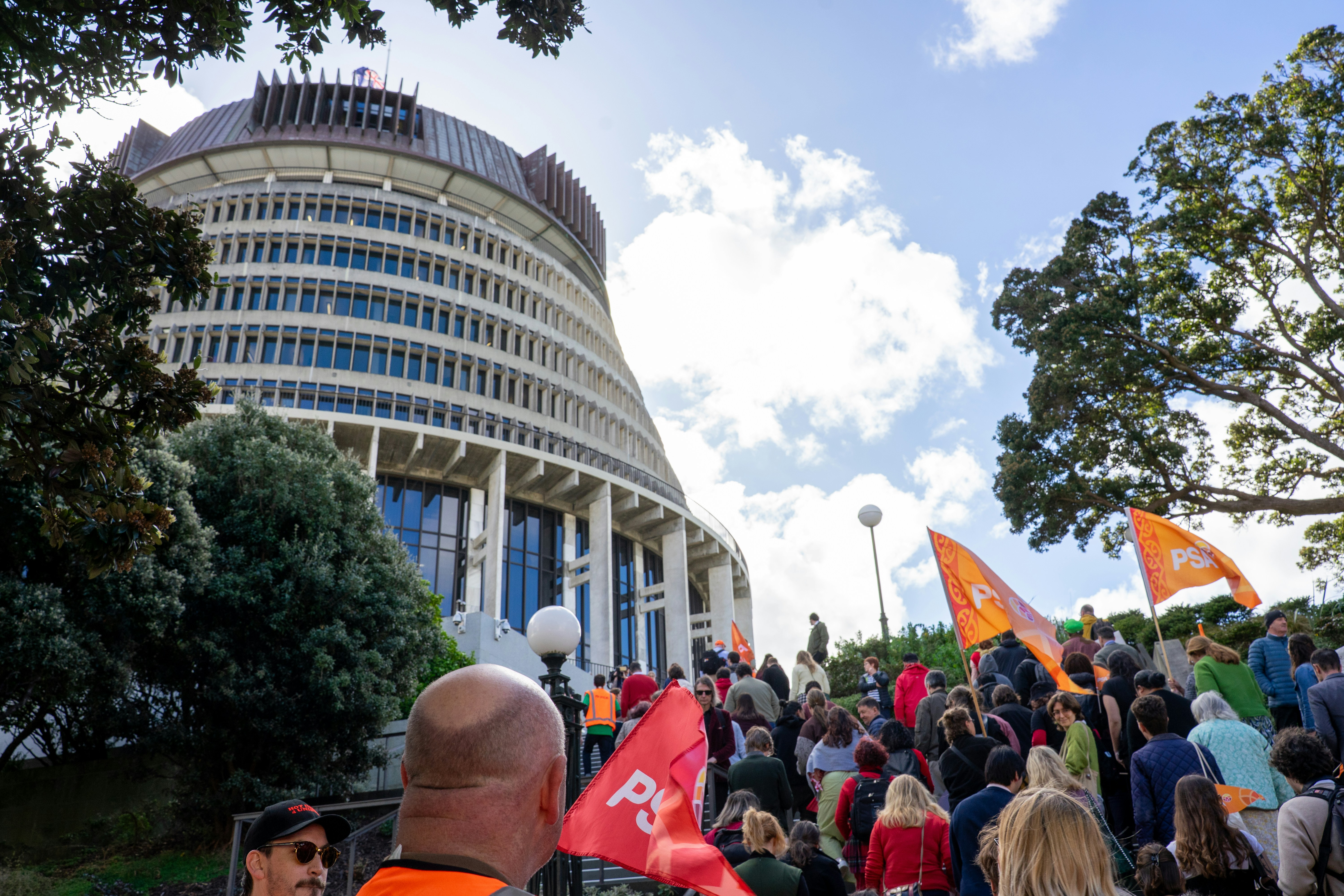 Protesters and union flags gather on steps beside the Beehive. 9 September 2026: PSA (Public Service Association) public