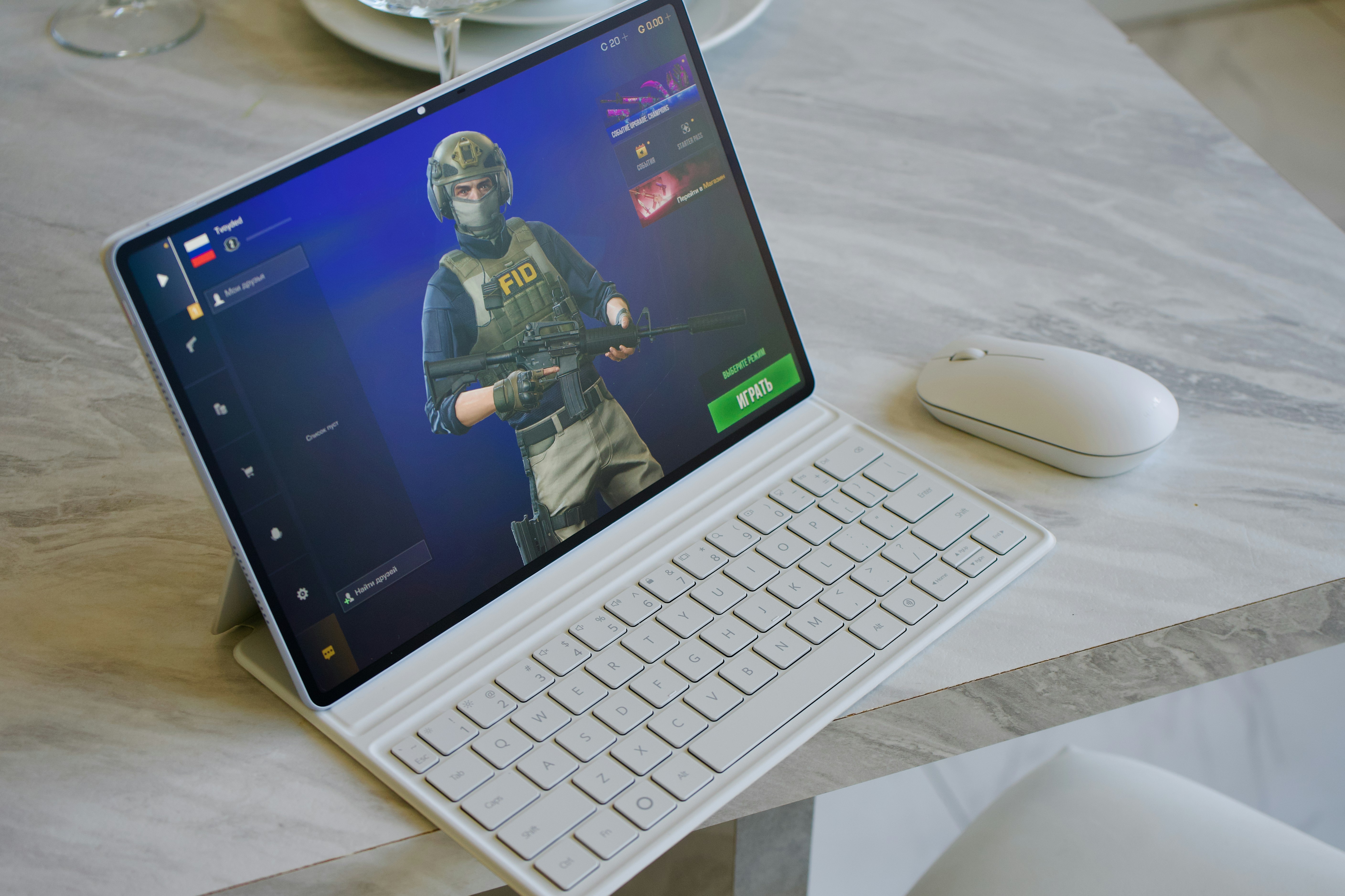 A tablet displaying a tactical video game character beside a white wireless mouse