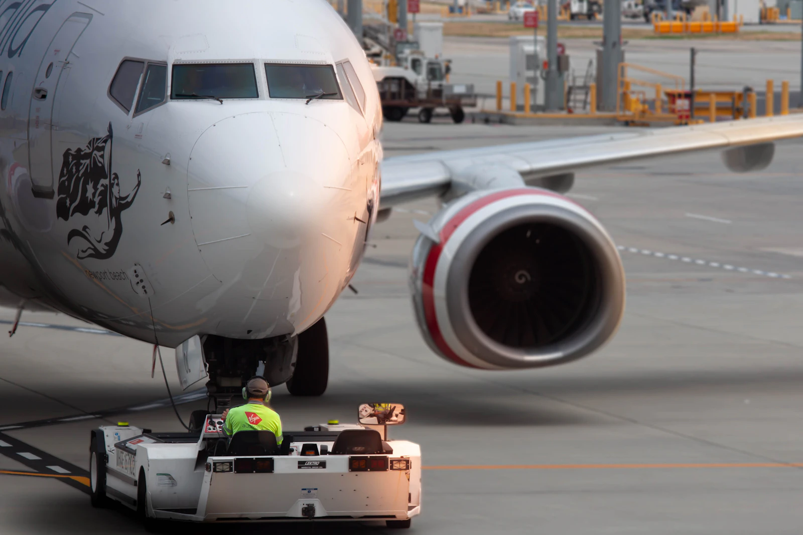Airport ramp crew in high-visibility uniforms near aircraft