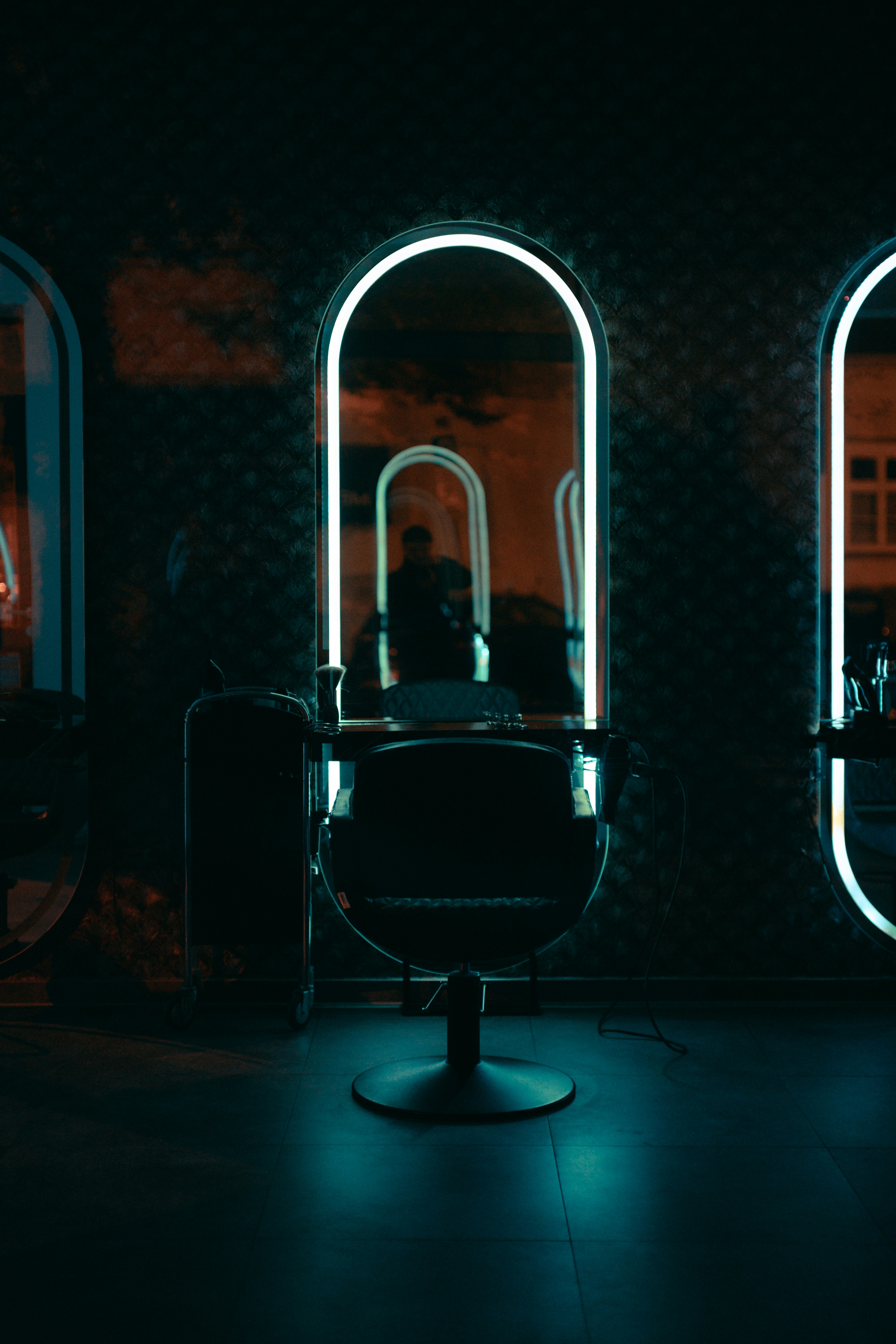 The studio's single window chair and mirror in afternoon light