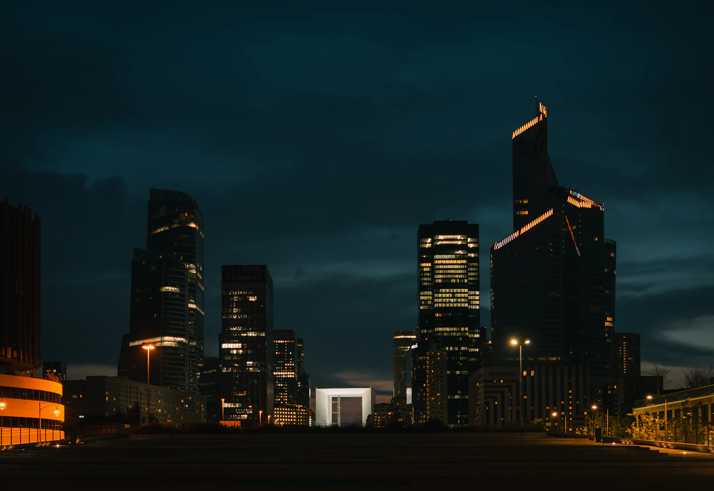 Modern skyscrapers lit up at night in the La Défense business district of Paris