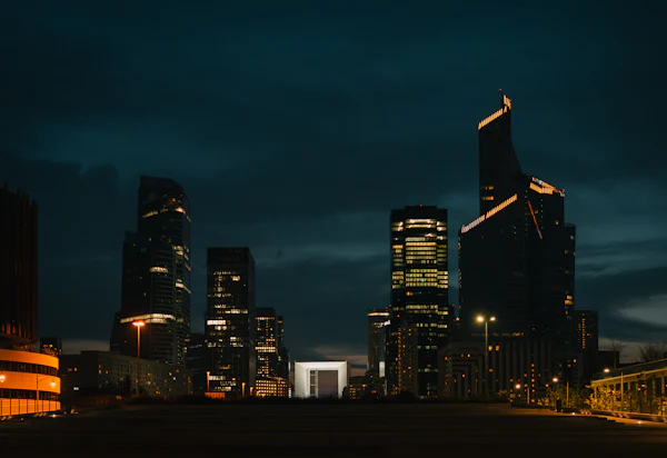 Modern skyscrapers lit up at night in the La Défense business district of Paris
