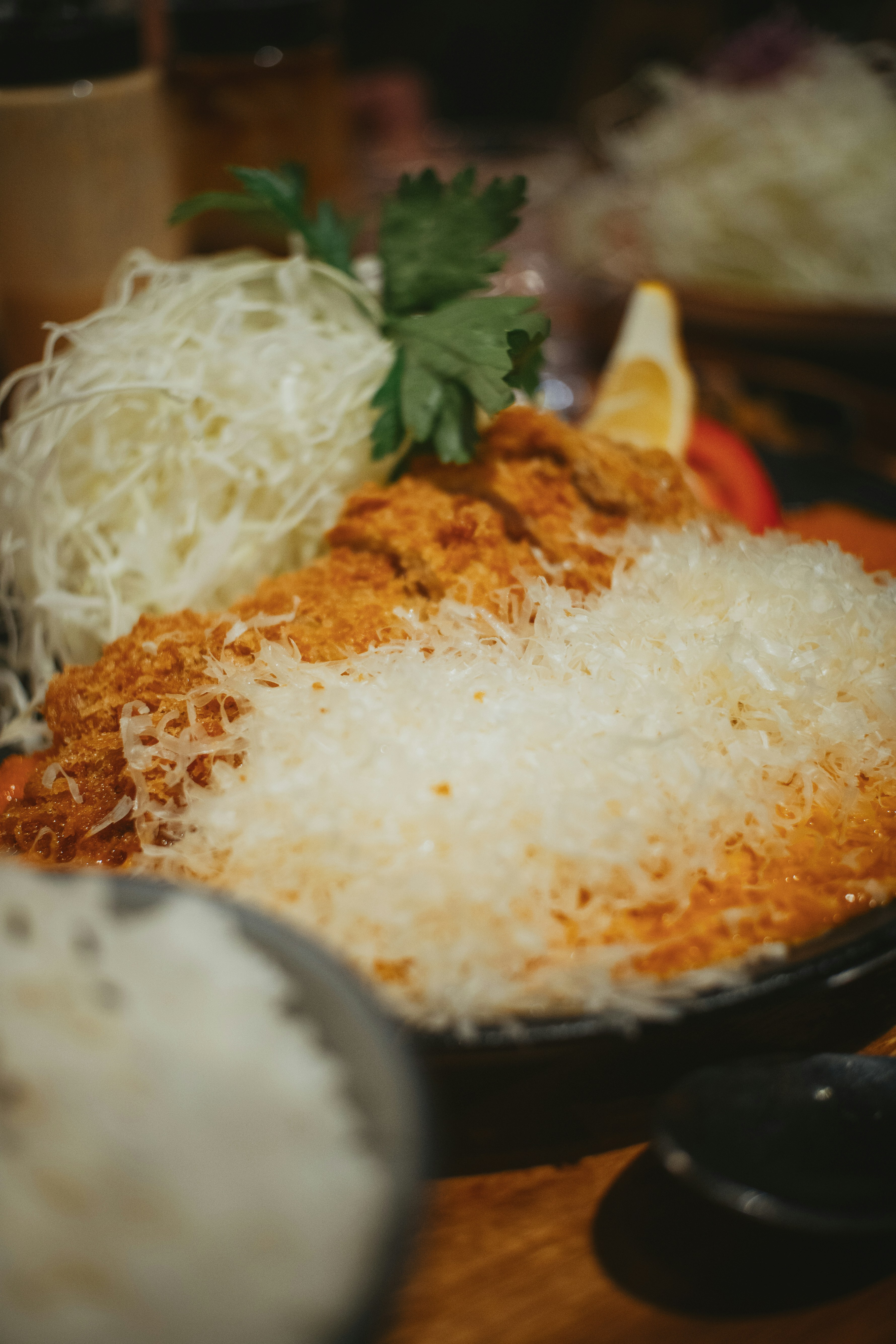 Crispy breaded pork cutlet with shredded cabbage and rice in a restaurant
