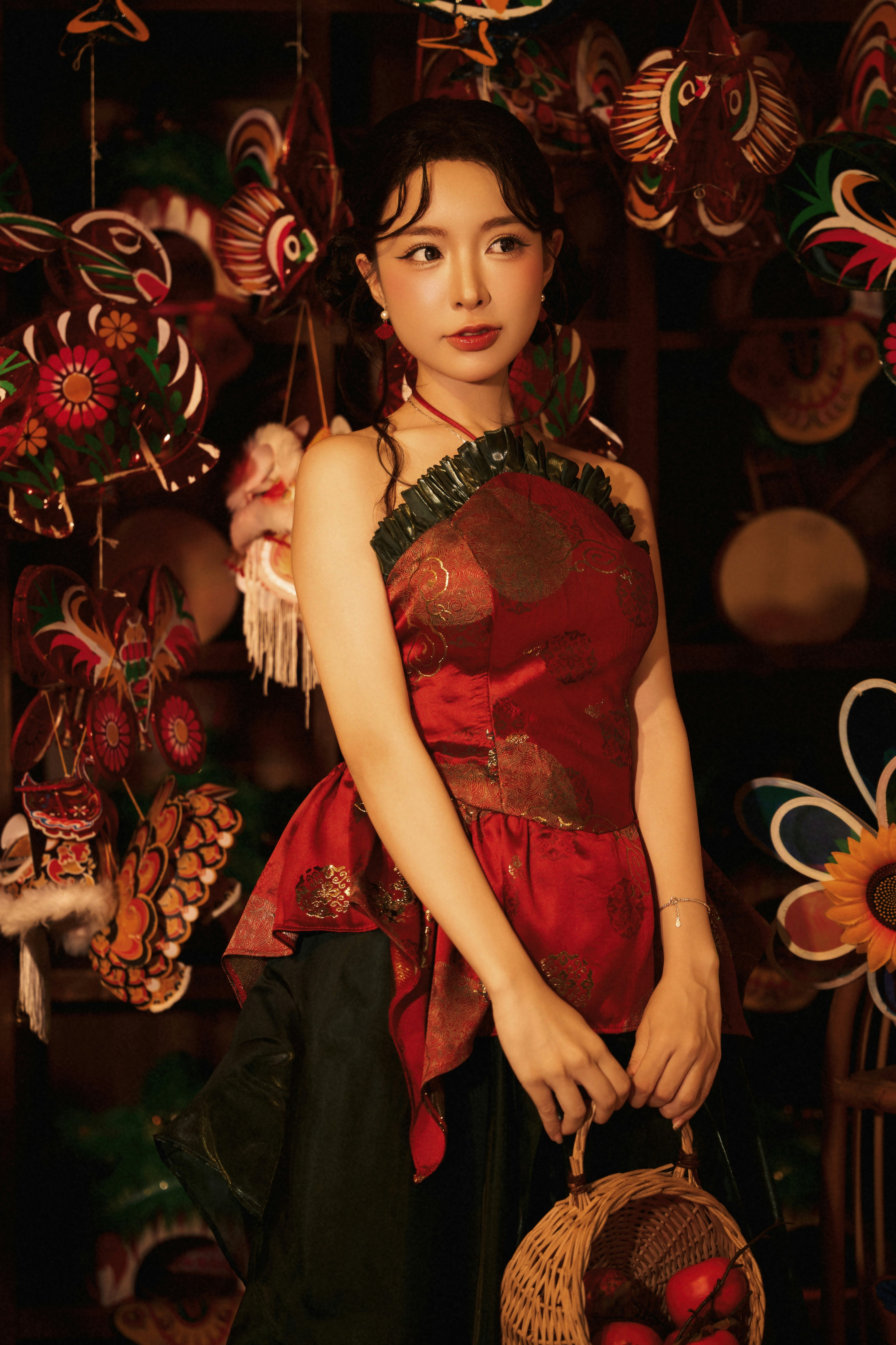 A woman in a red patterned top holding a small wicker basket