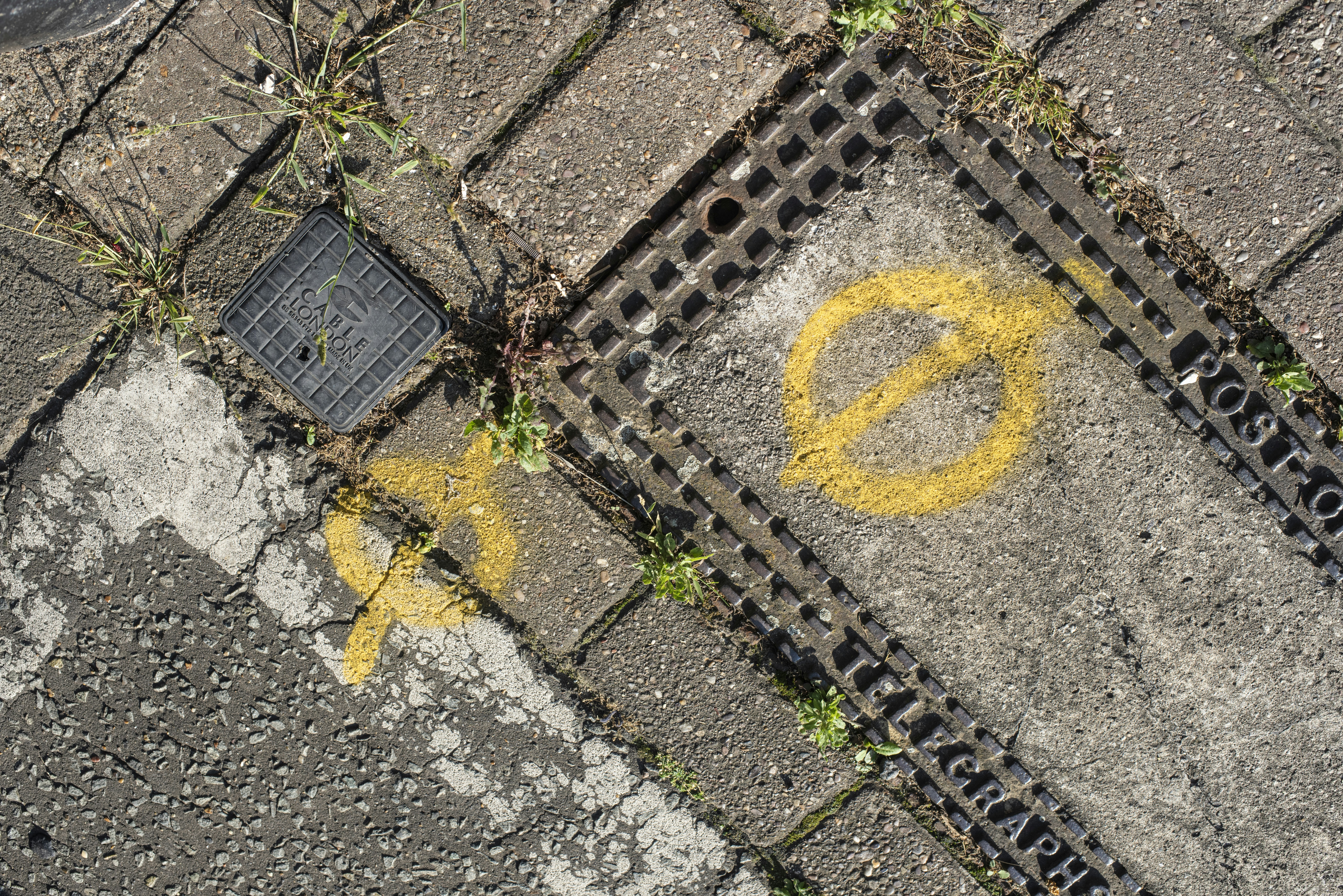 The battered pavement of a north London Street.