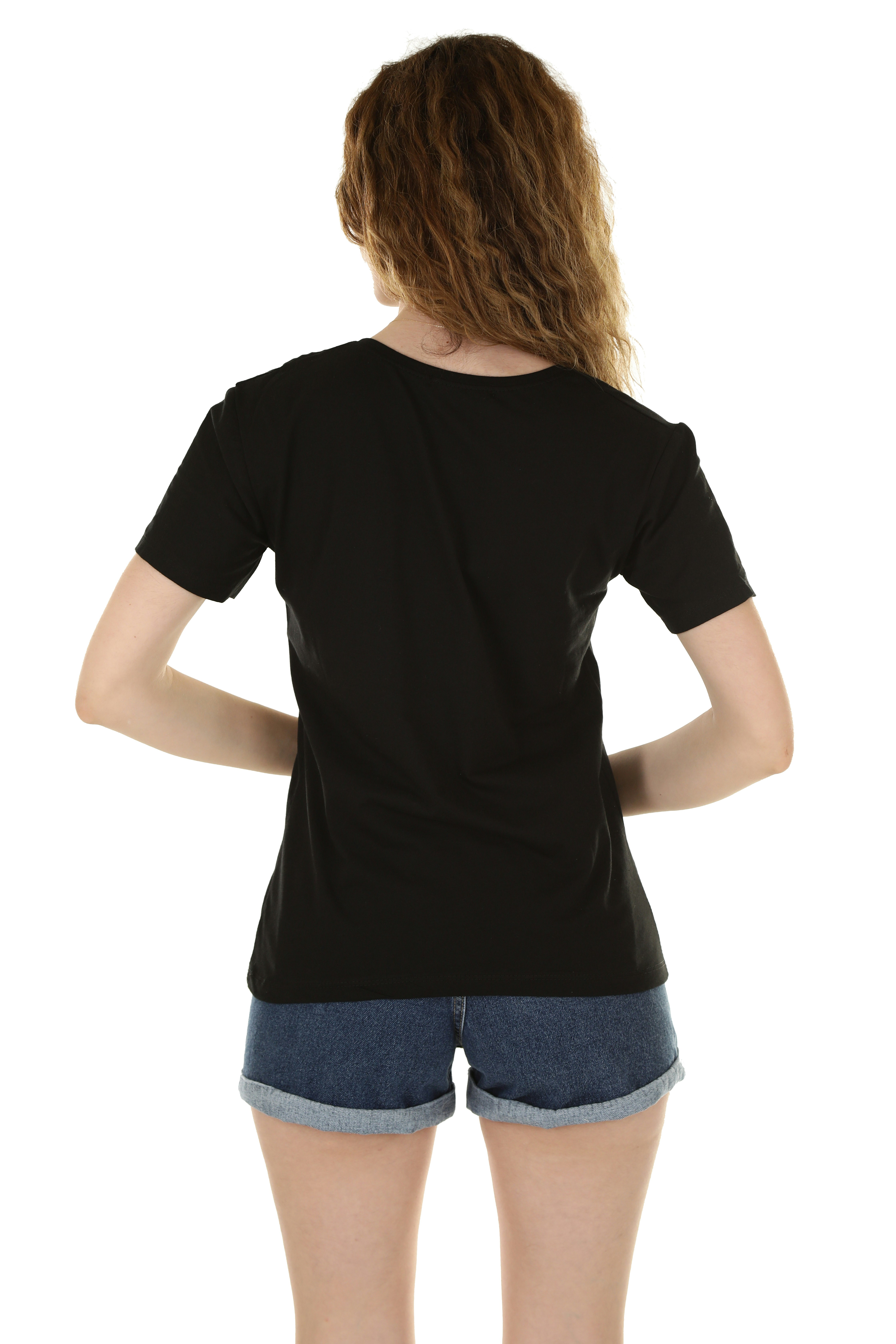 A woman with curly hair wearing a black t-shirt and denim shorts
