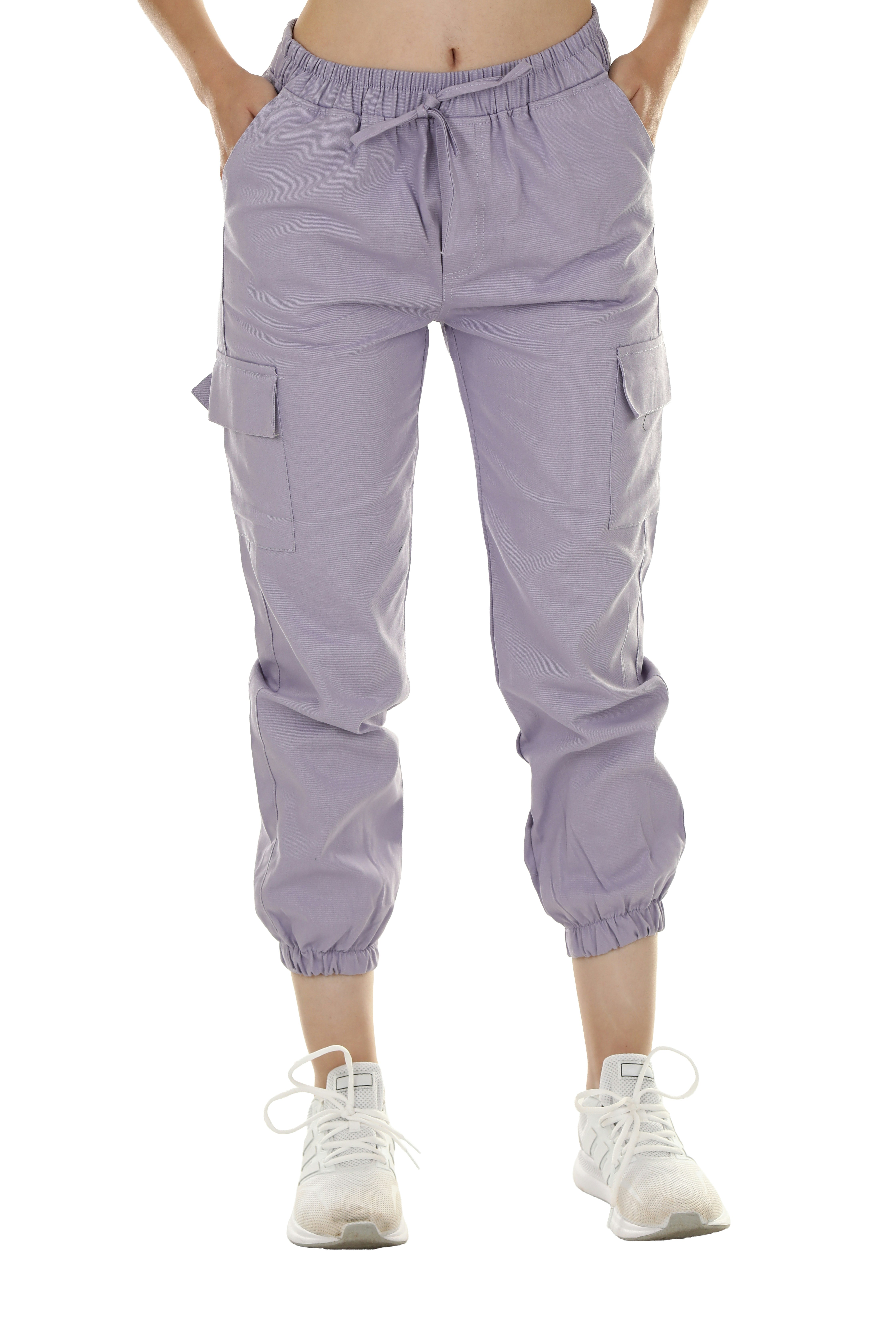 A person wearing lavender cargo pants with a drawstring waist and white sneakers