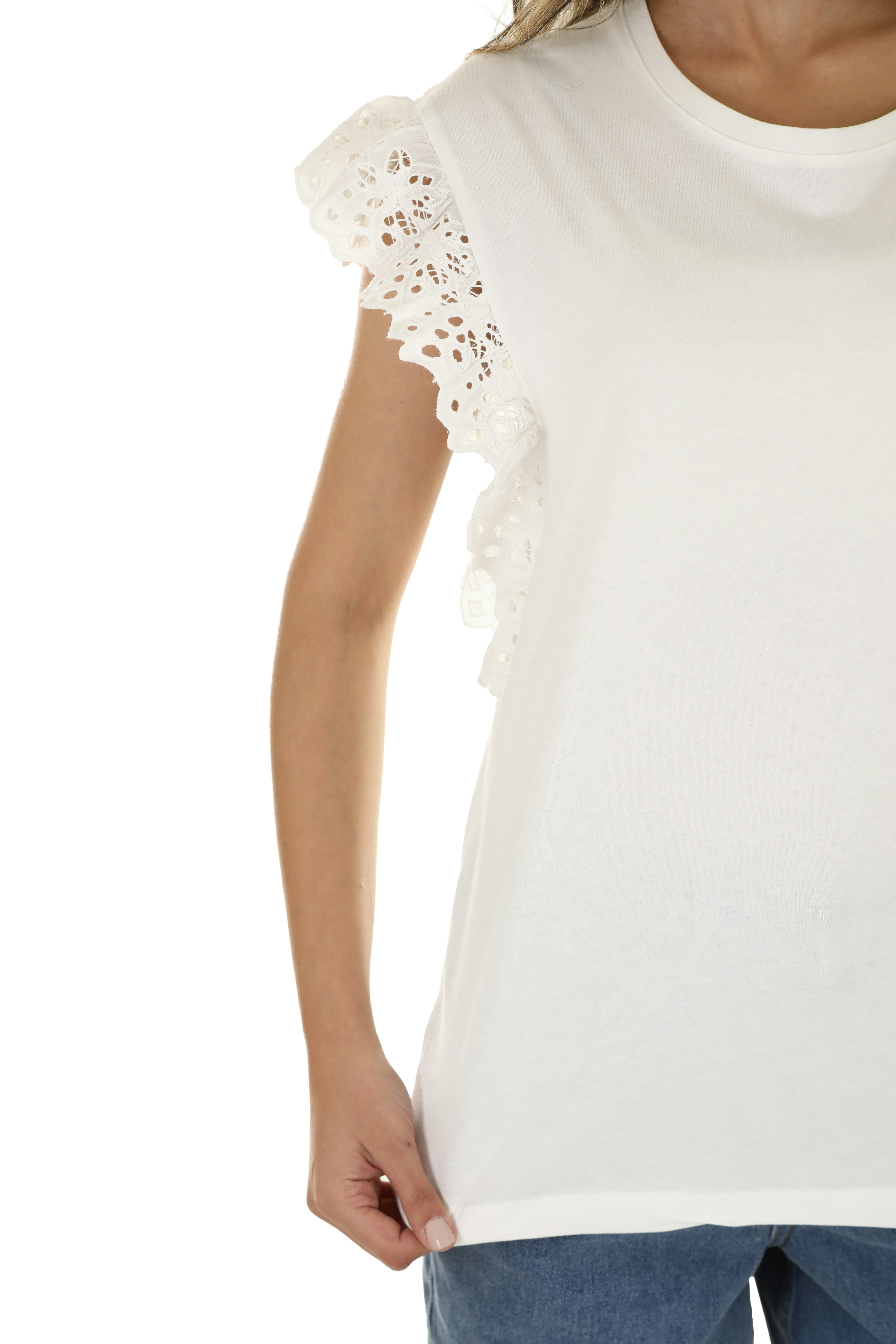 A person wearing a white t-shirt with lace flutter sleeves and blue jeans
