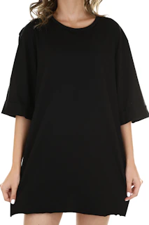 A person wearing an oversized black t-shirt with cuffed sleeves