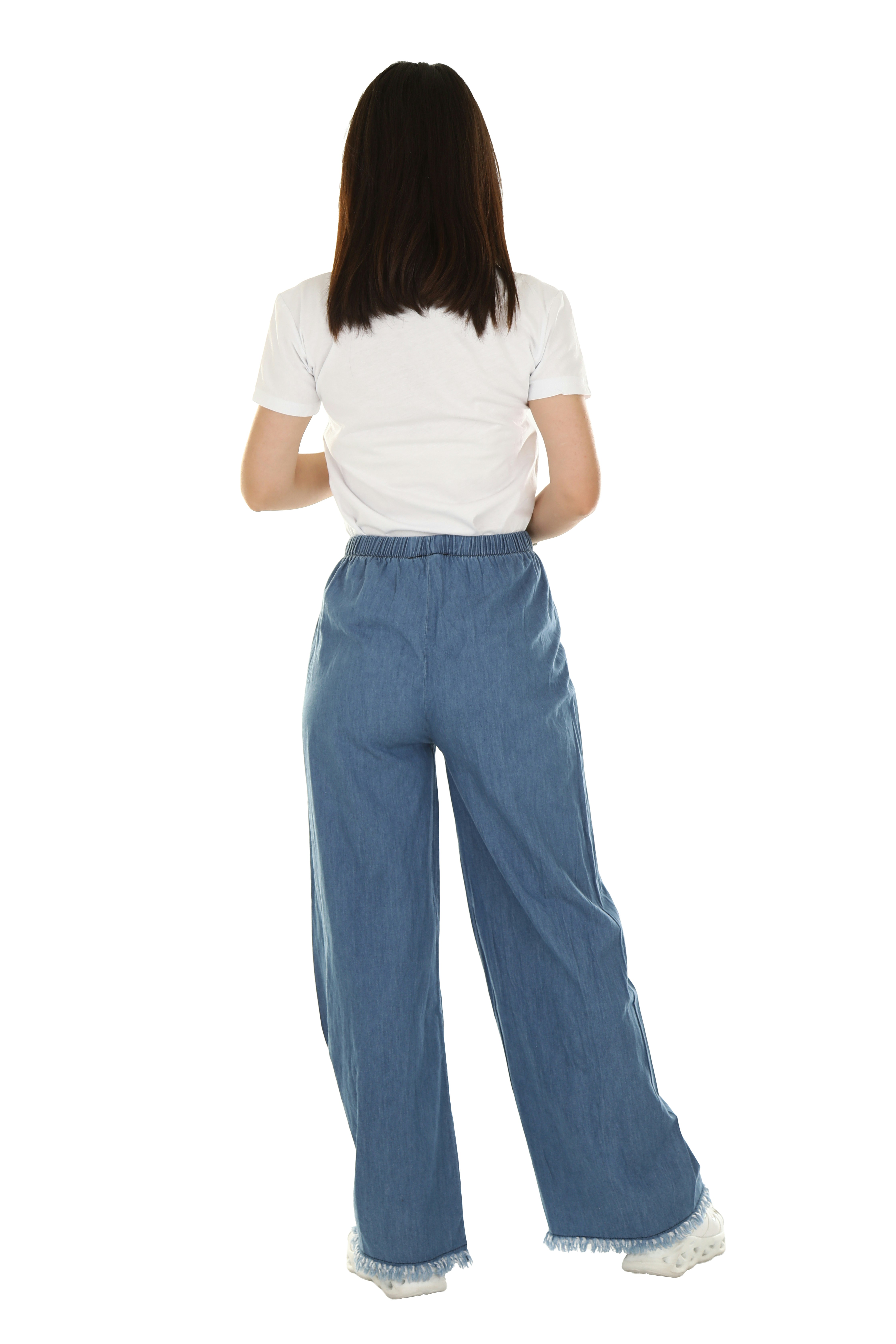 A woman in a white t-shirt and blue denim trousers seen from behind