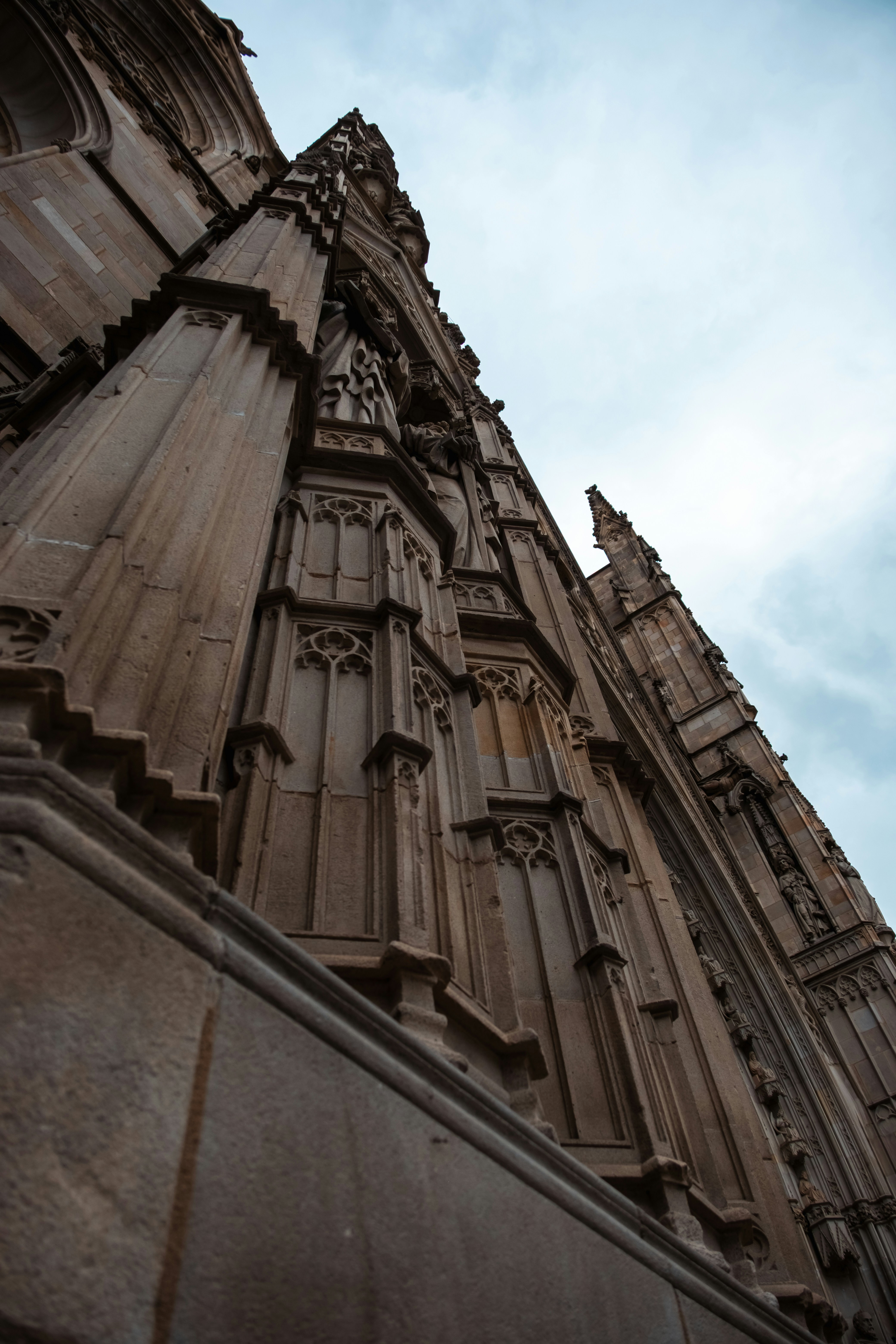 Low angle view of a gothic stone cathedral facade with intricate carvings