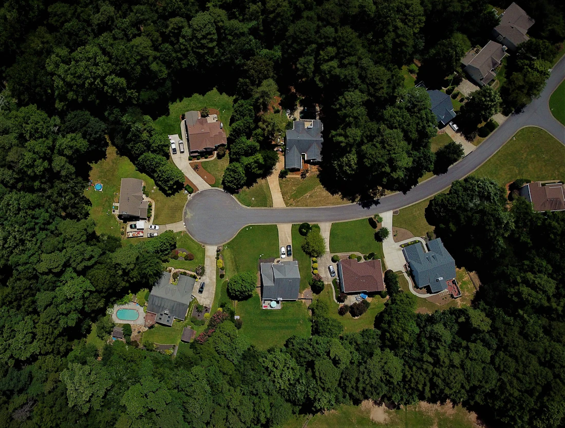 Aerial view of a wooded cul-de-sac neighborhood