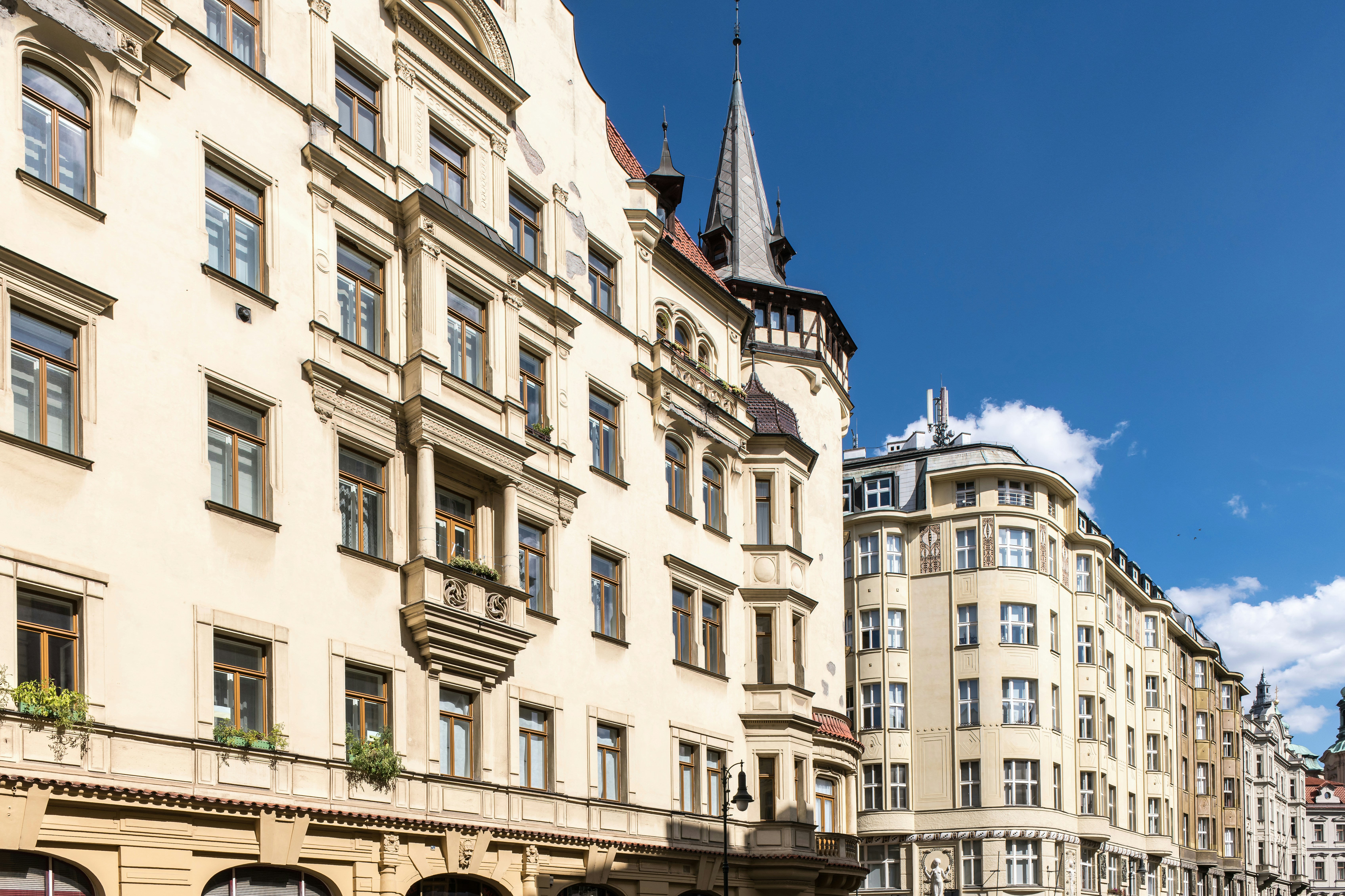 Ornate cream-colored apartment buildings with tall windows under a clear blue sky