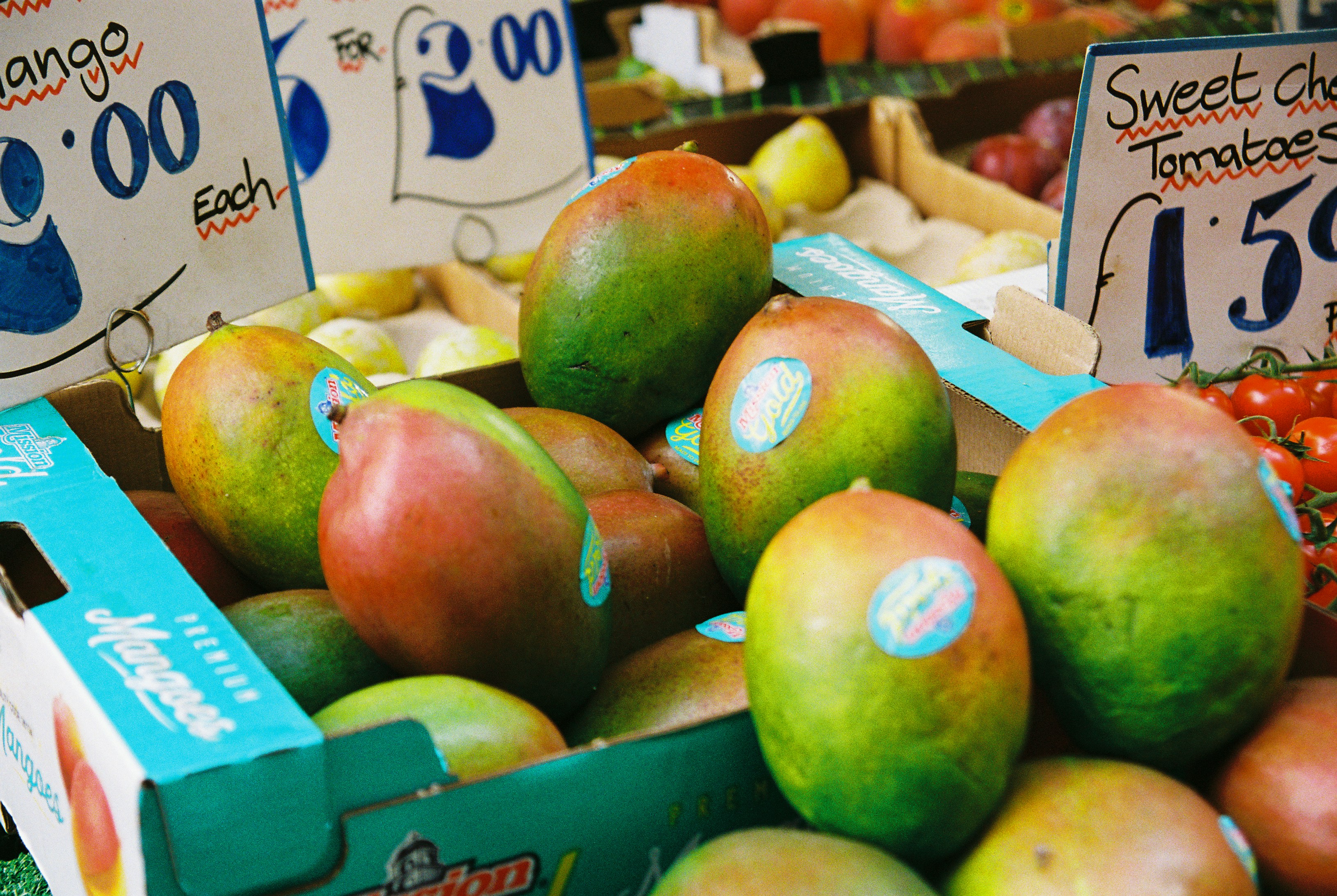 Mangoes in a crate with price signs