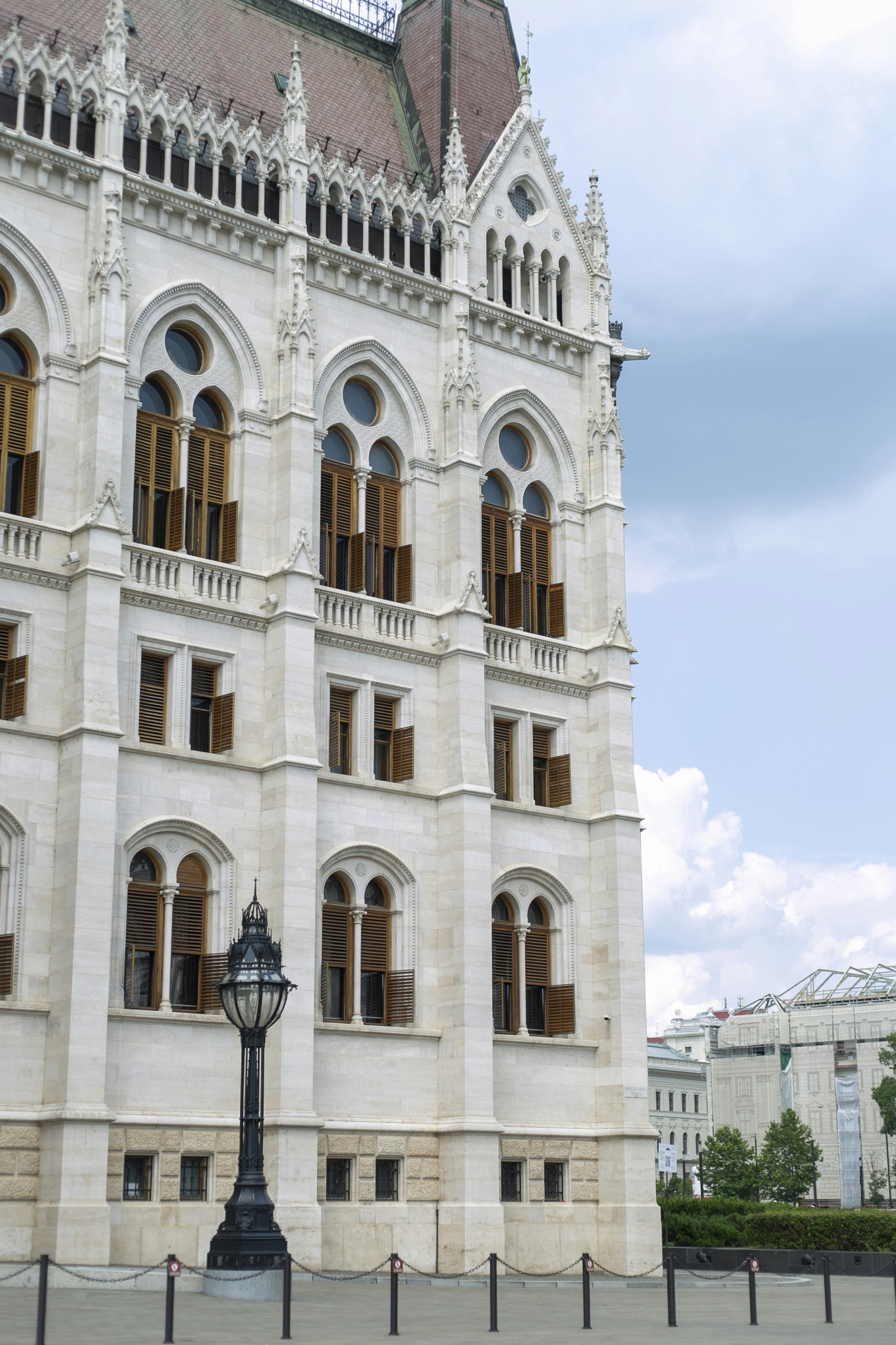 The Hungarian Parliament Building facade with arched windows and wooden shutters in Budapest