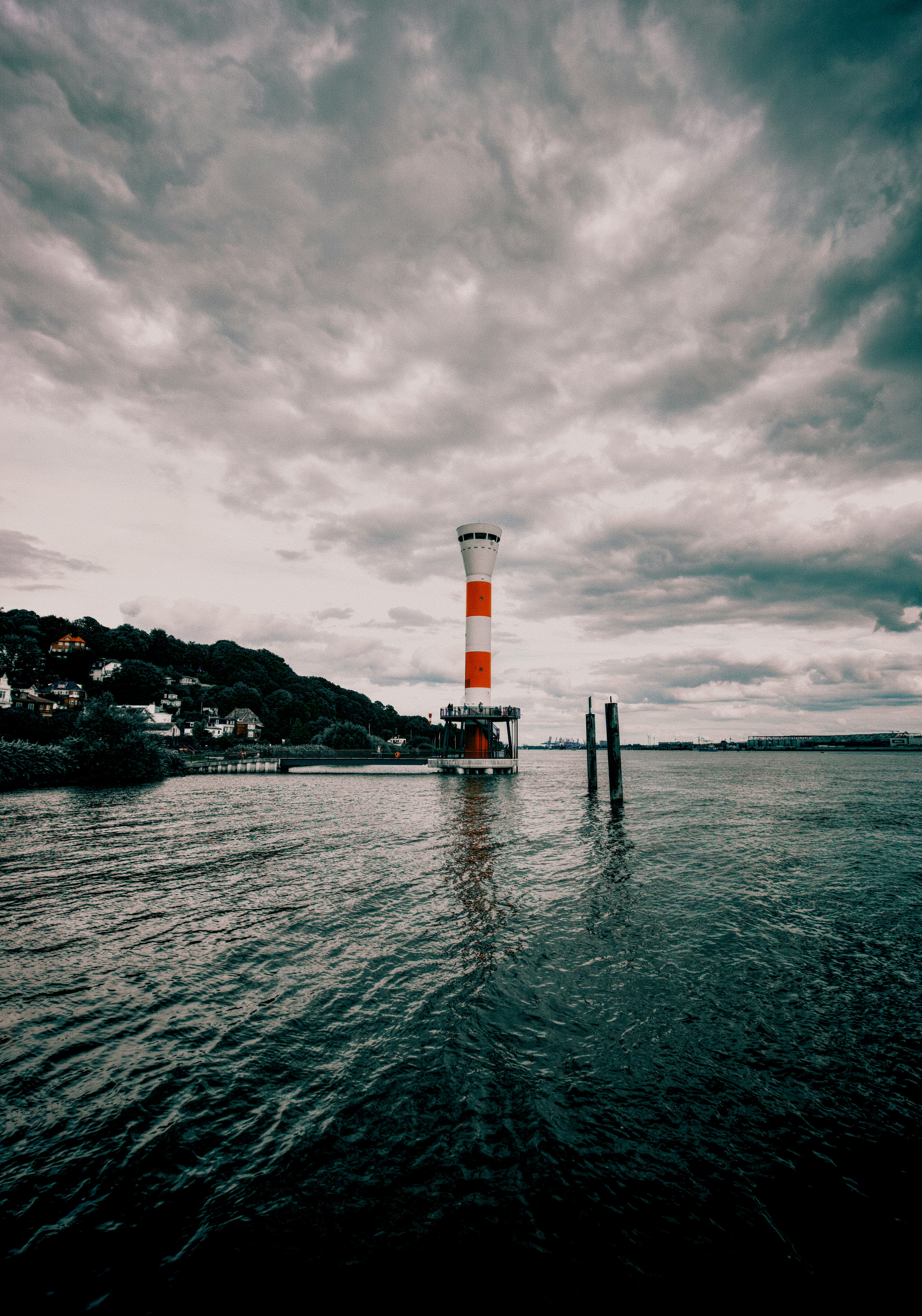 A red and white lighthouse on a platform in the Elbe river near Blankenese
