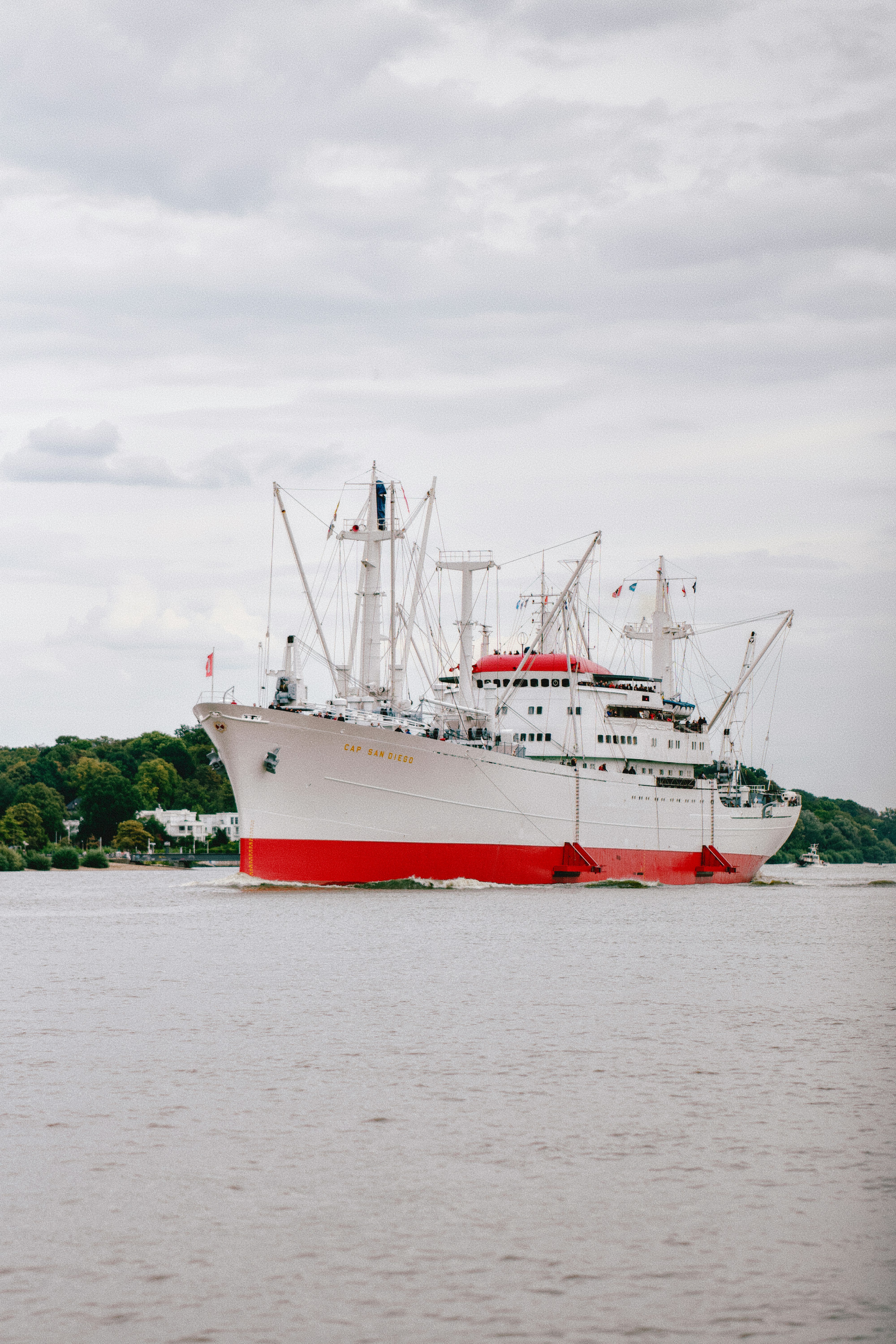 The Cap San Diego cargo ship sailing on a river under a cloudy sky