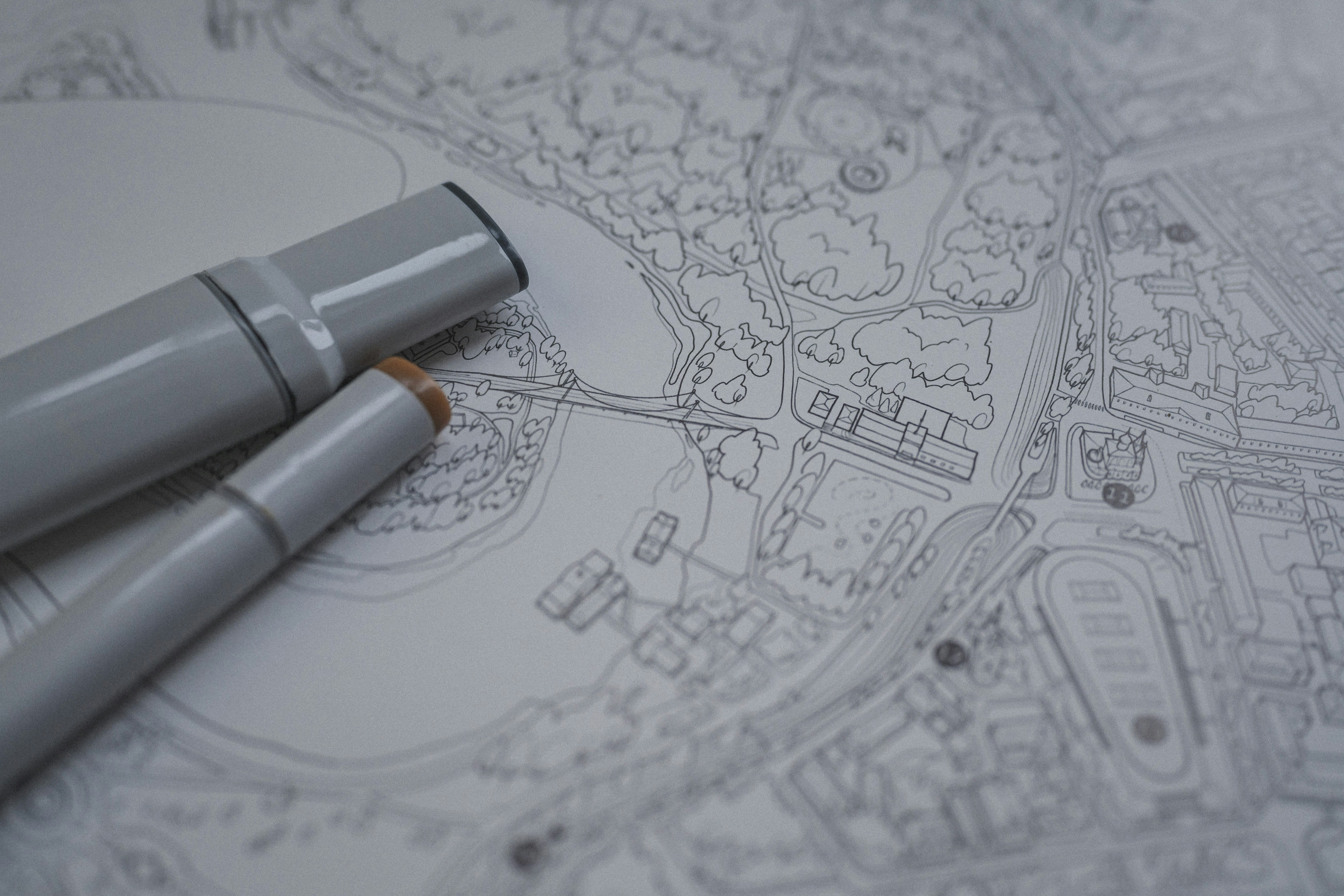 Two grey markers resting on a detailed black and white line map
