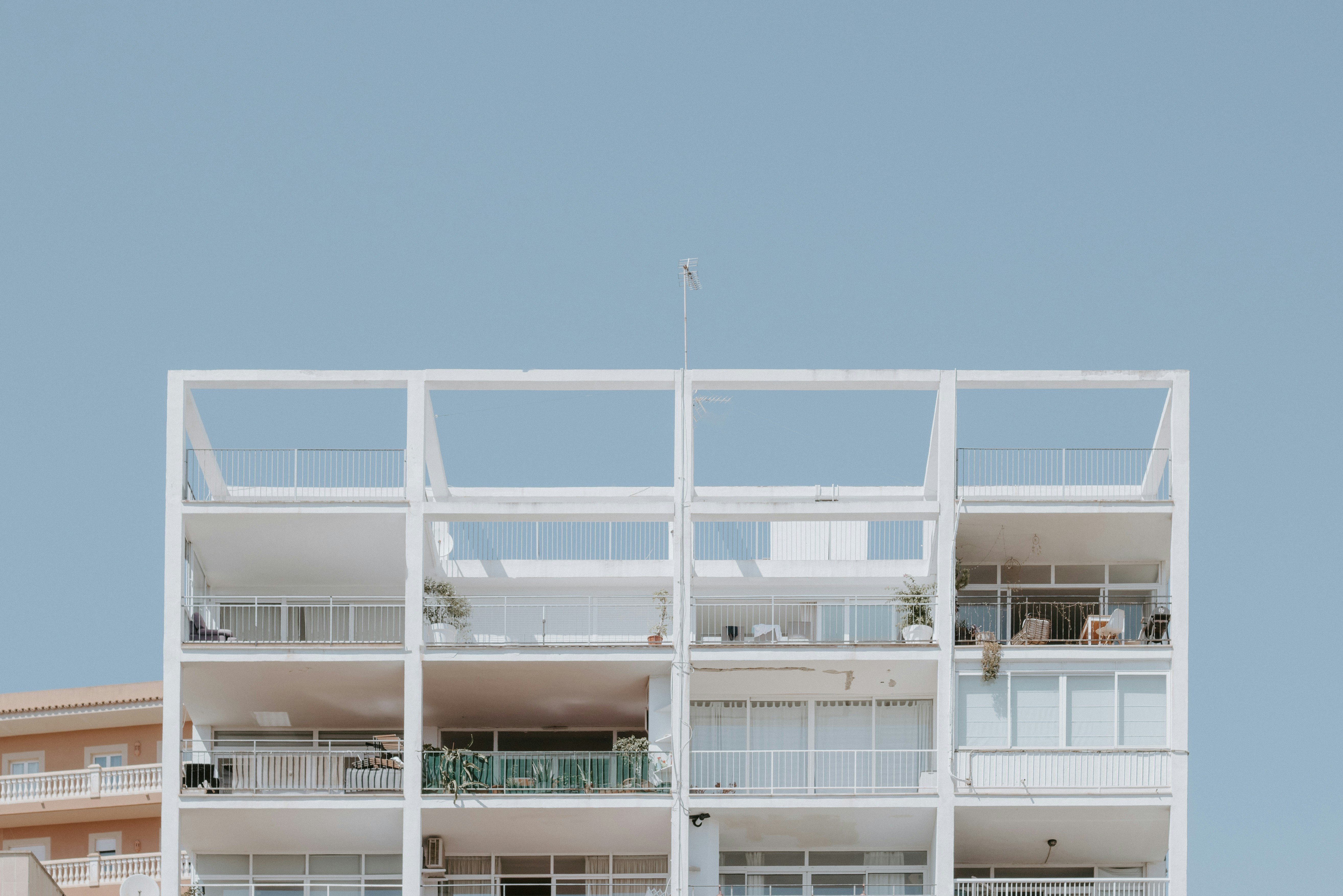 White apartment building with open balconies