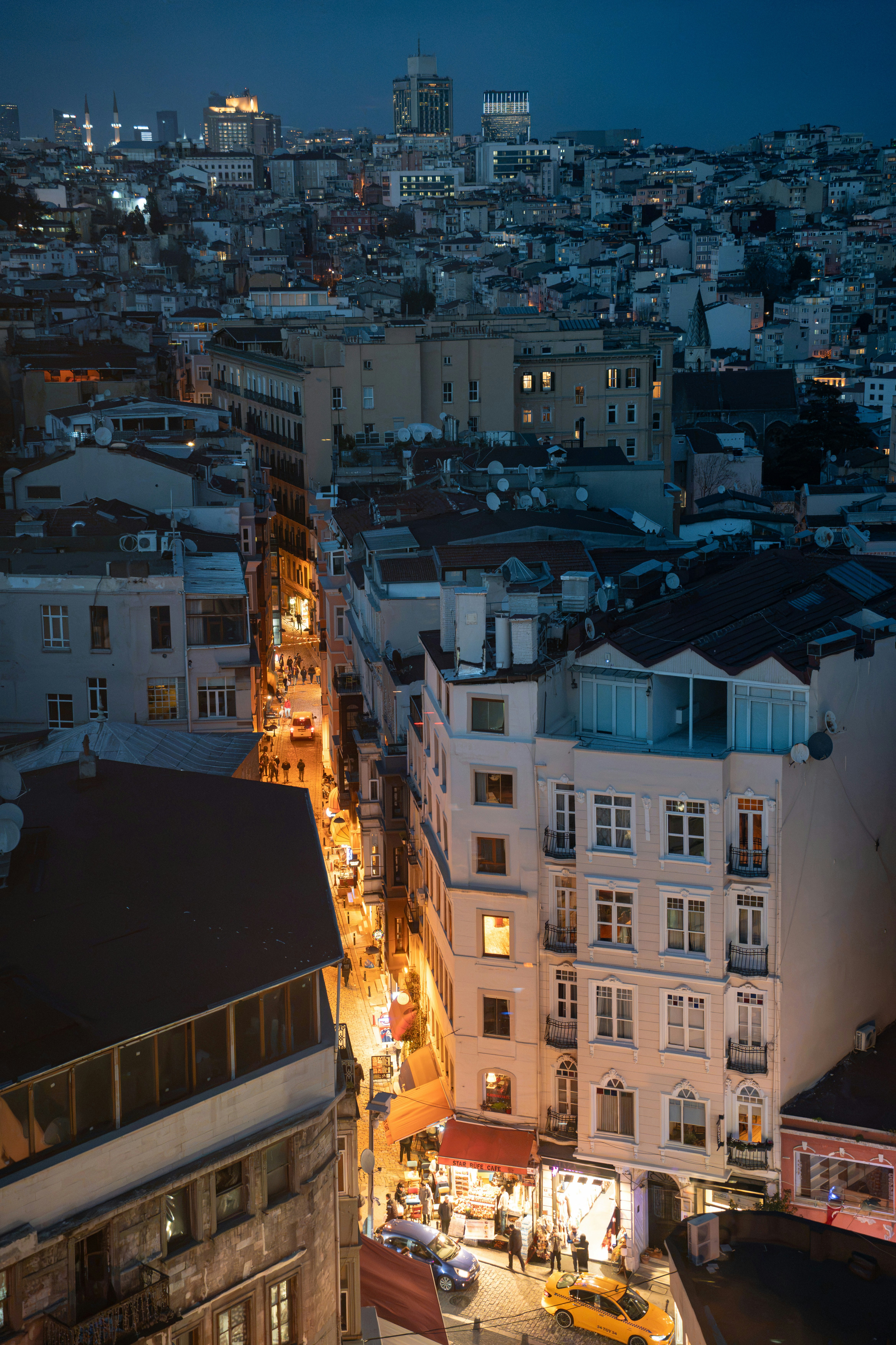 A narrow street in Istanbul illuminated by warm lights at night