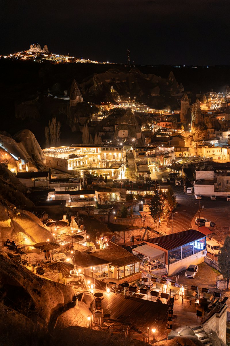 Lit cave dwellings and rock-cut houses in Göreme, Cappadocia, glowing at night