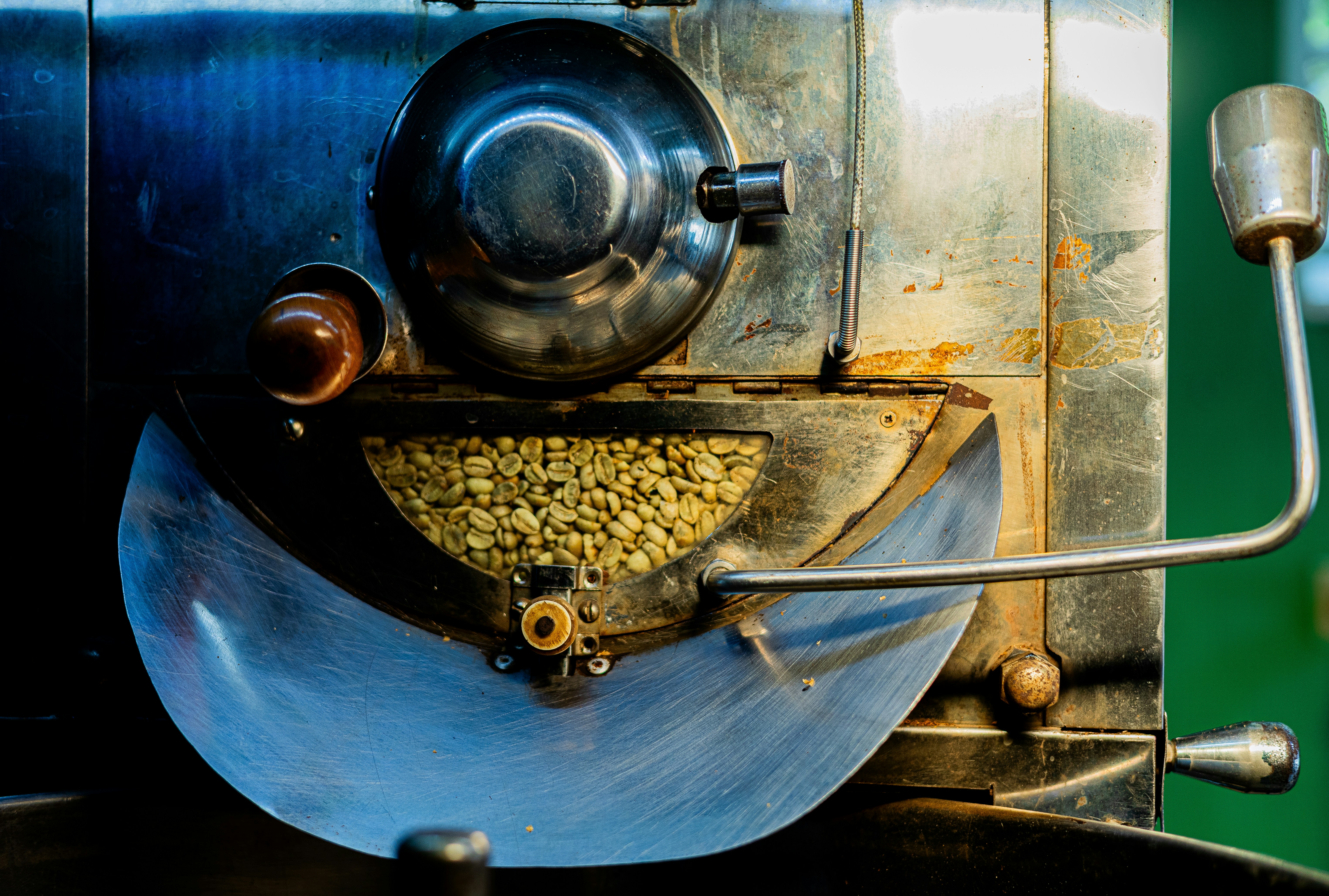 Unroasted green coffee beans inside a roaster