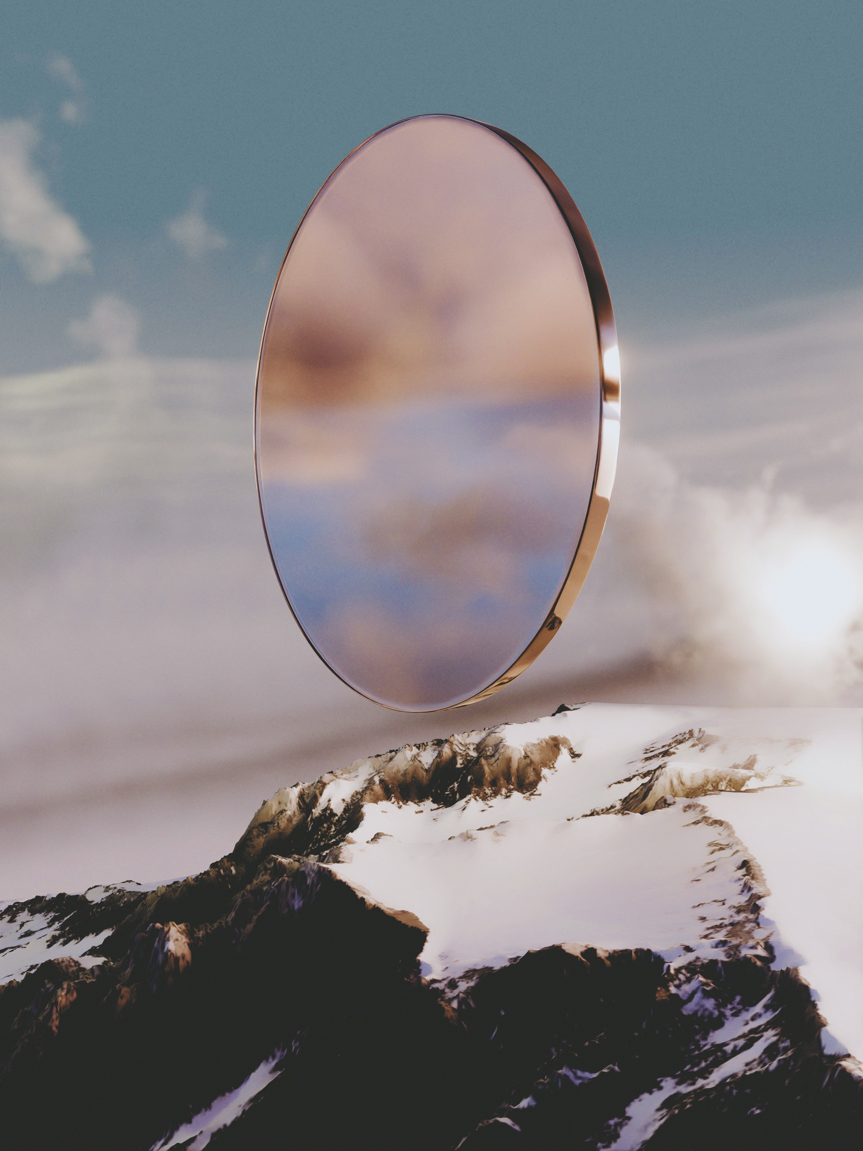 A circular mirror floating above a snow-covered mountain peak against a cloudy sky