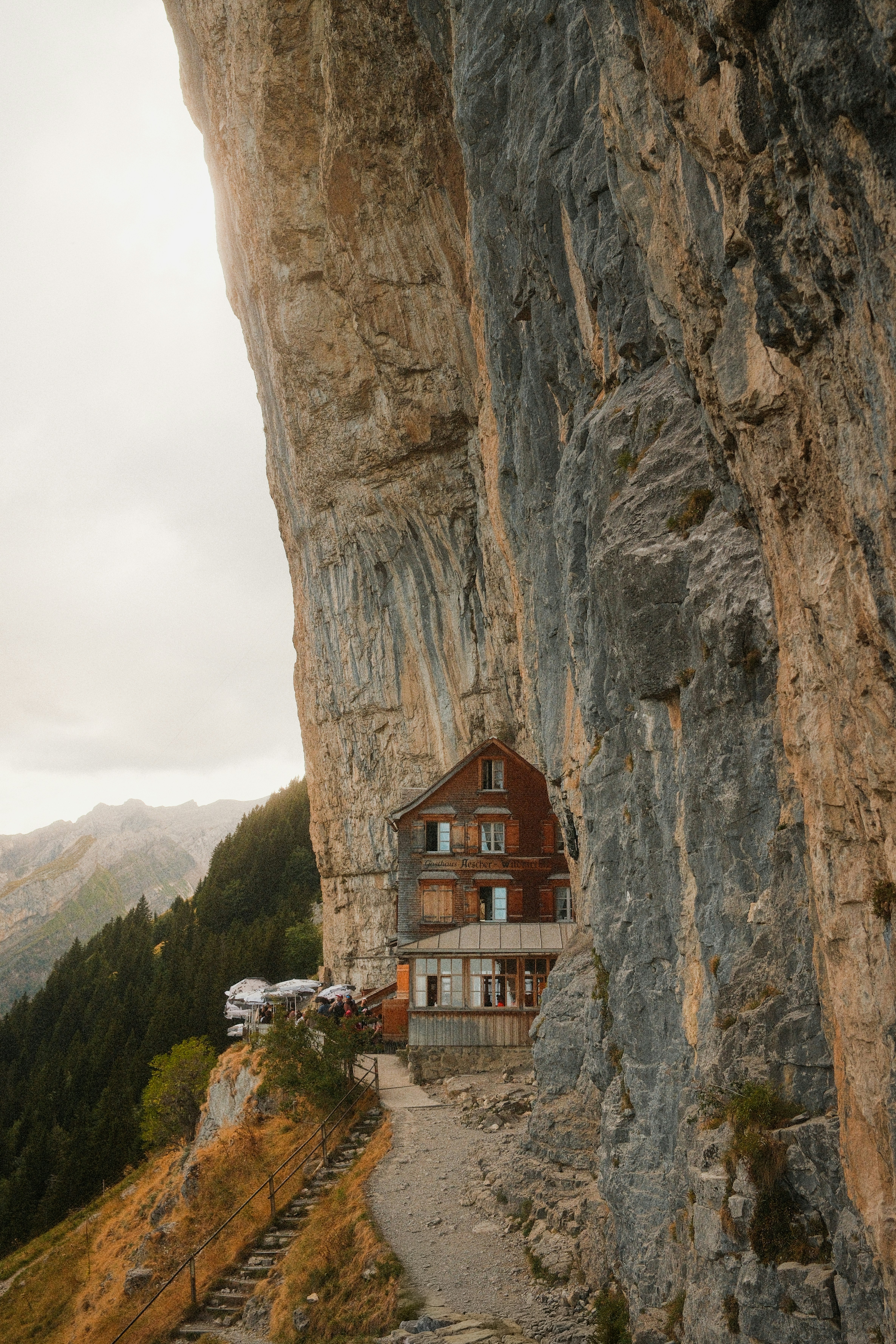 A wooden mountain inn built into a cliffside in Schwende-Rüte, Switzerland