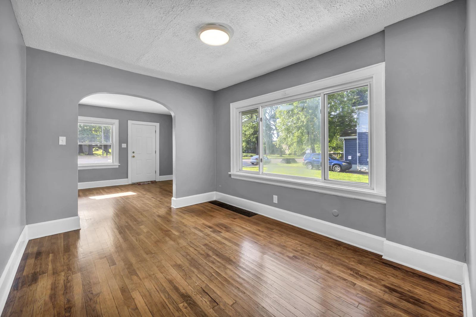 Empty room with gray walls and hardwood floors
