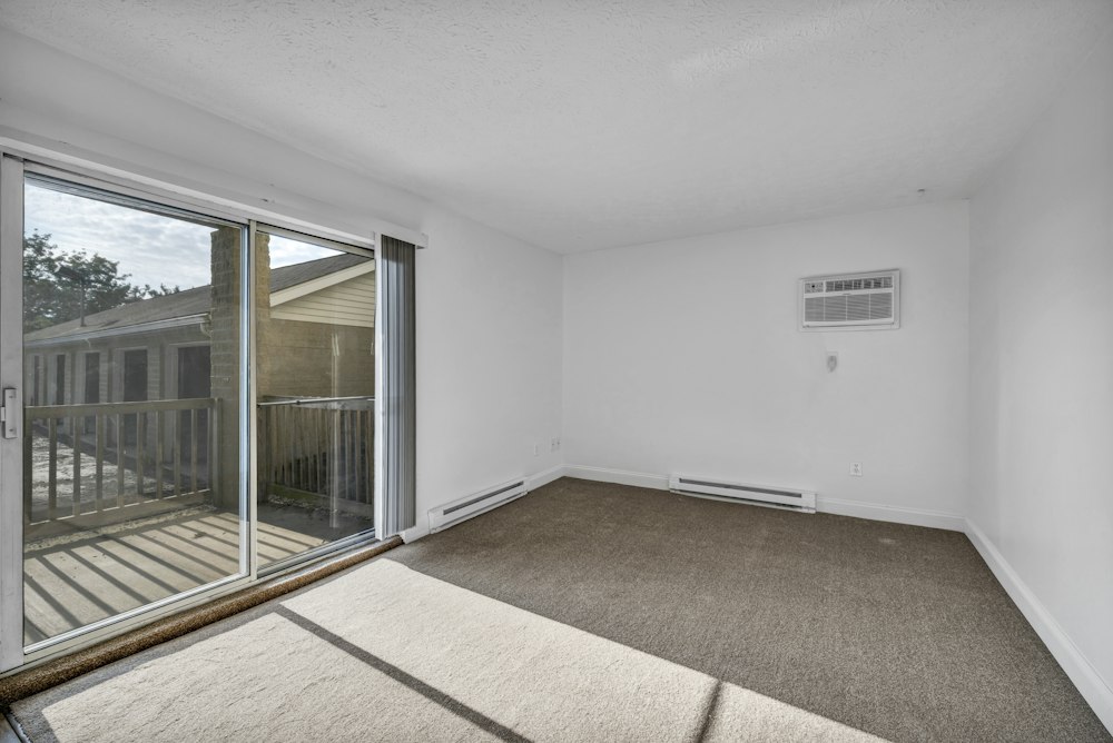 Empty rental bedroom with clean carpet ready for final inspection