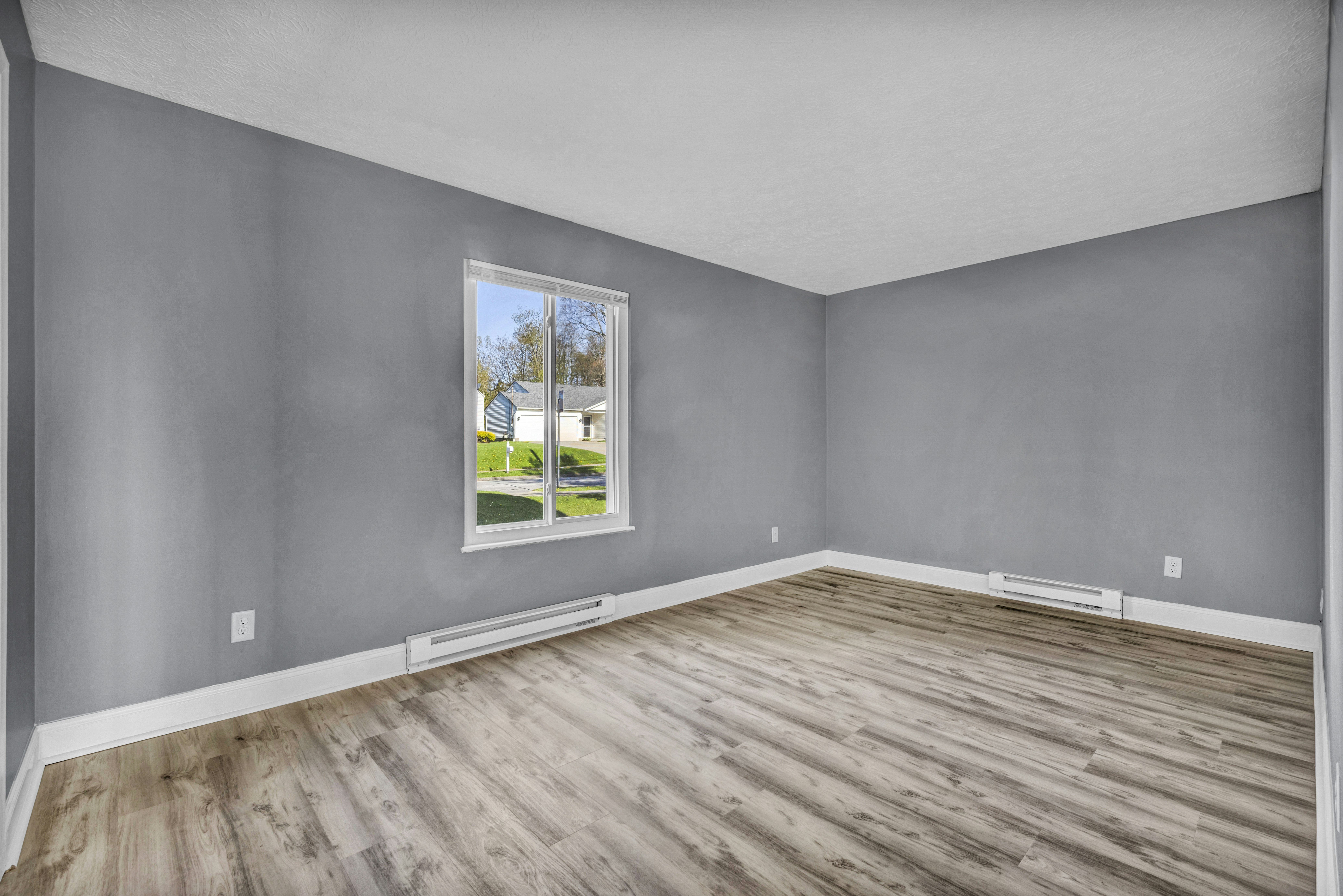 Empty room with grey walls and white trim