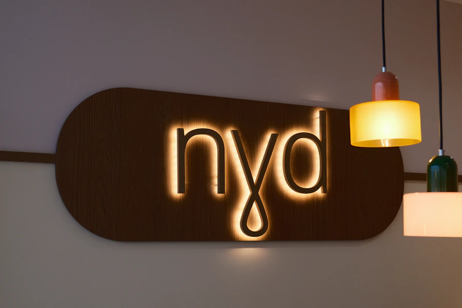 Backlit brand sign on a wooden plaque
