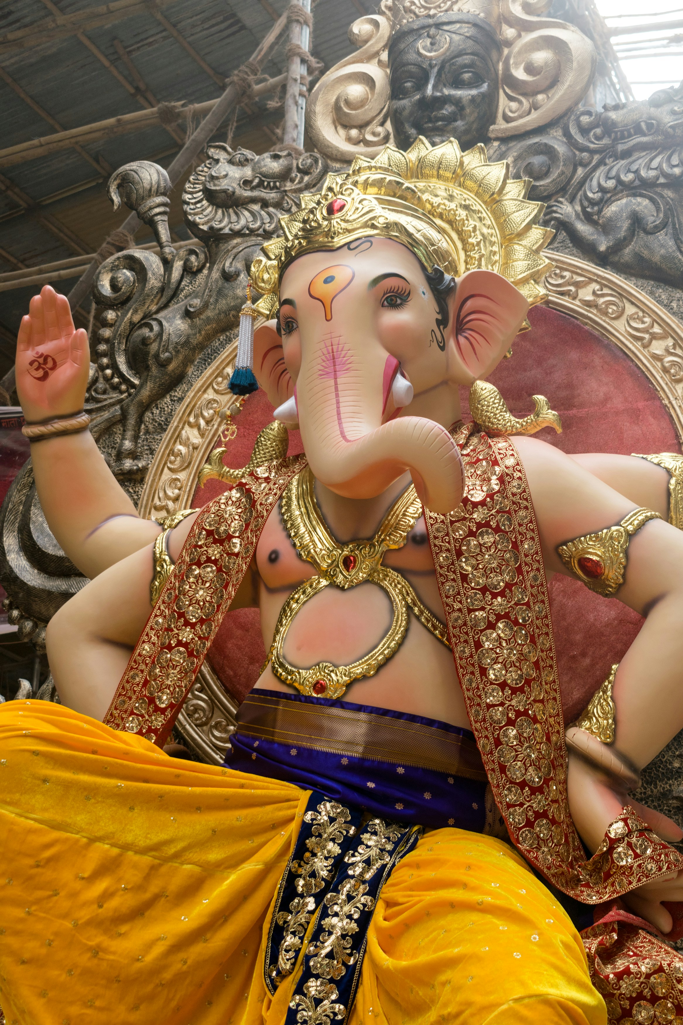 A large statue of Lord Ganesha with golden ornaments in Mumbai, India