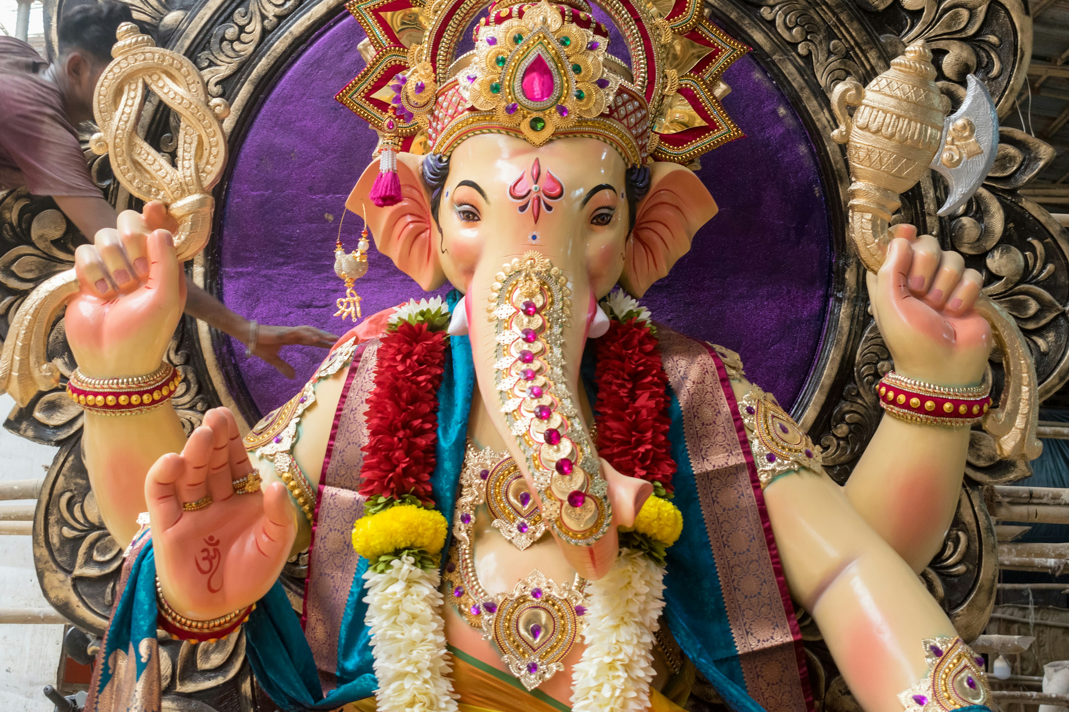 A decorated Ganesha statue with garlands and jewelry in Mumbai, India