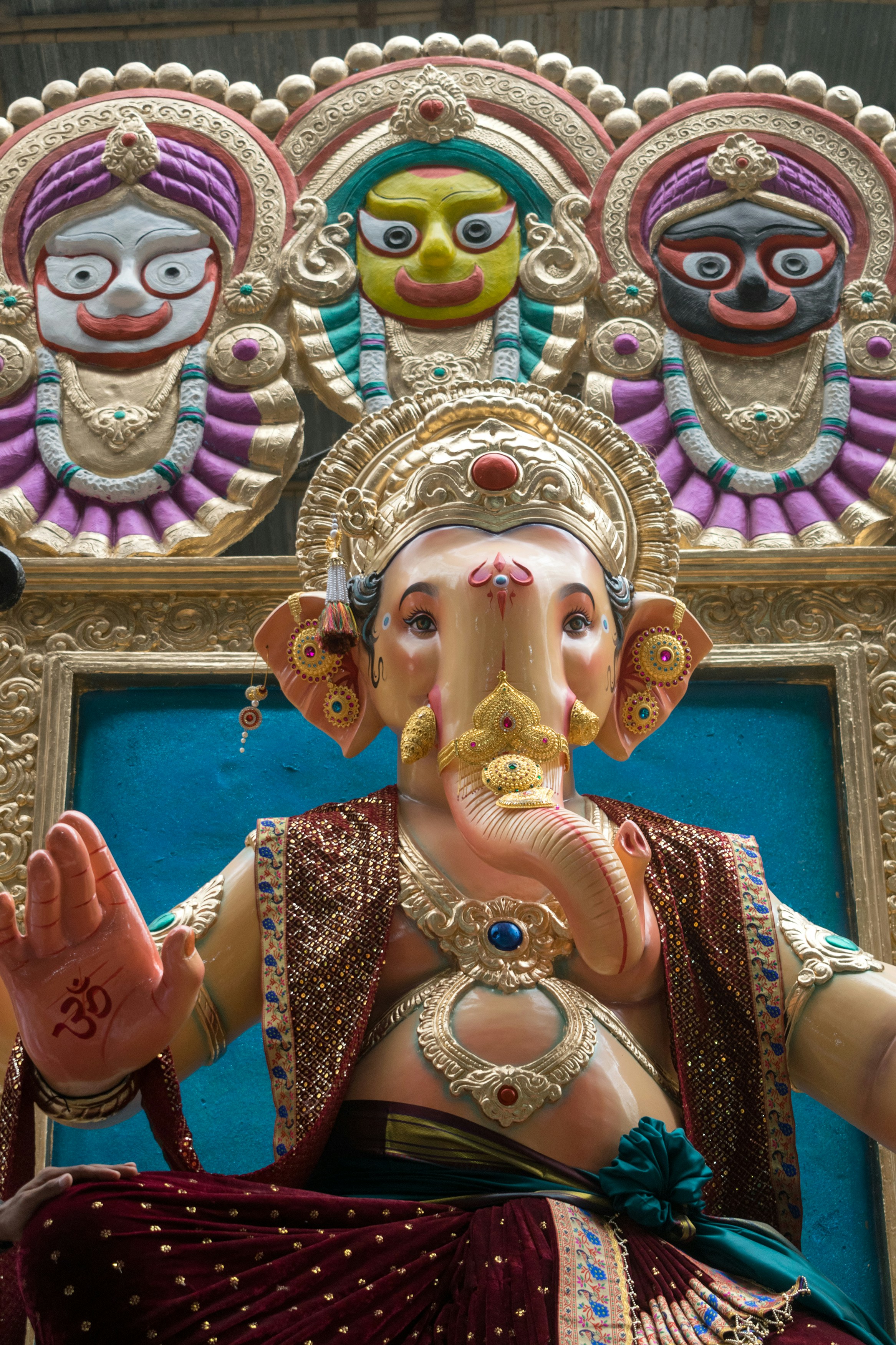 A colorful Ganesha statue with an ornate golden crown in Mumbai, India