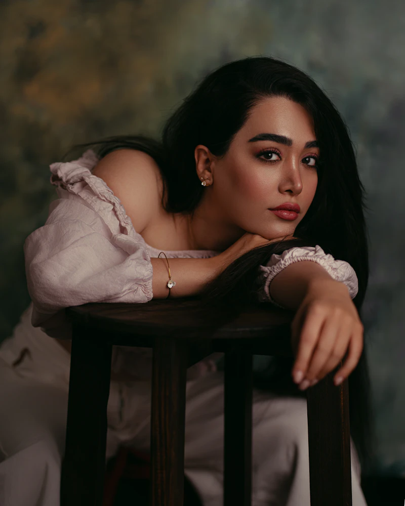 Portrait leaning on a wooden stool