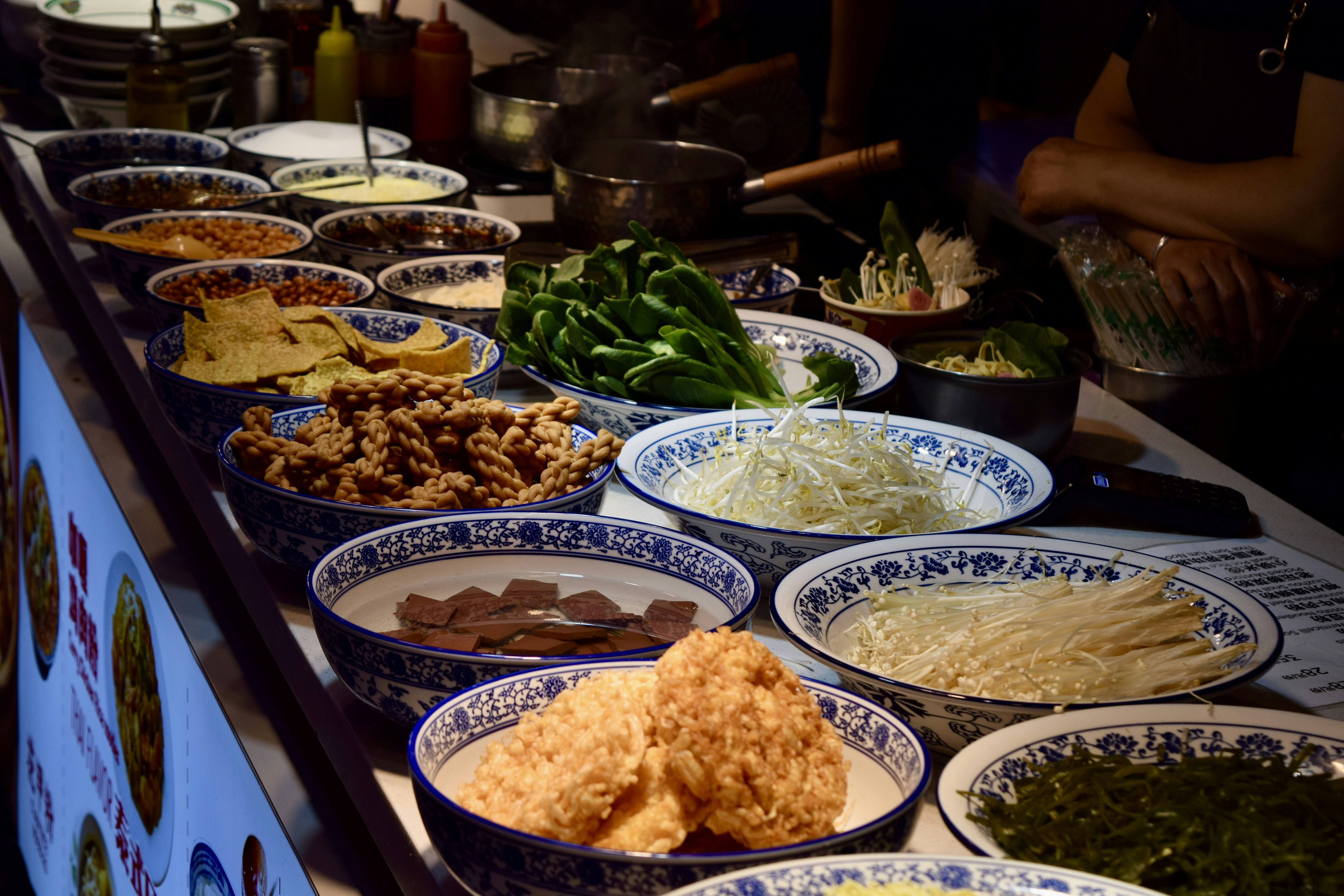 Bowls of fresh ingredients at a buffet counter