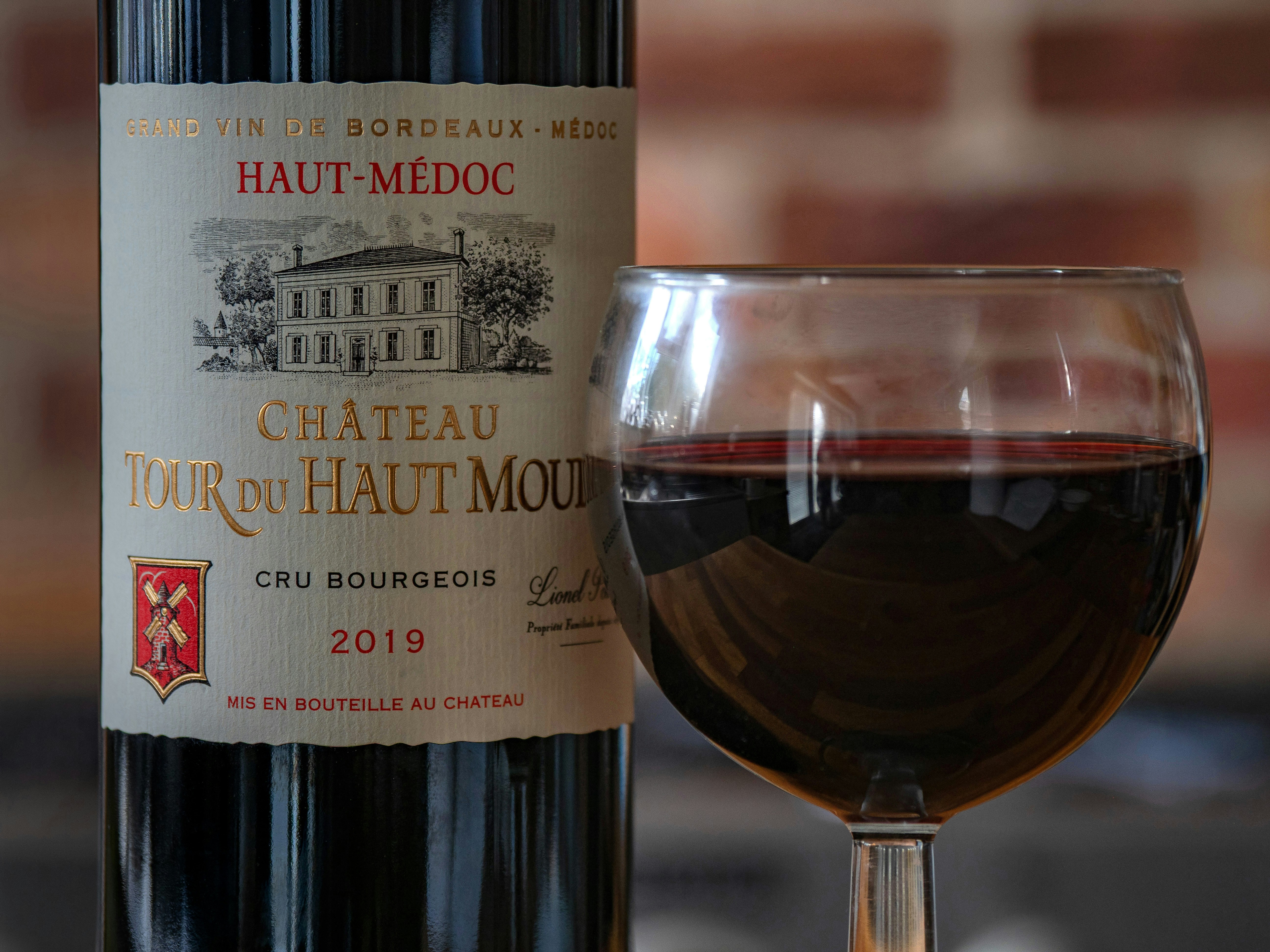 wine, red wine, alcohol, product shot, blurred background, bokeh, wine glass, haut medoc, grand vin de bordeaux, chateau tour du haut Moulin, cru bourgeois, 2019, french,
