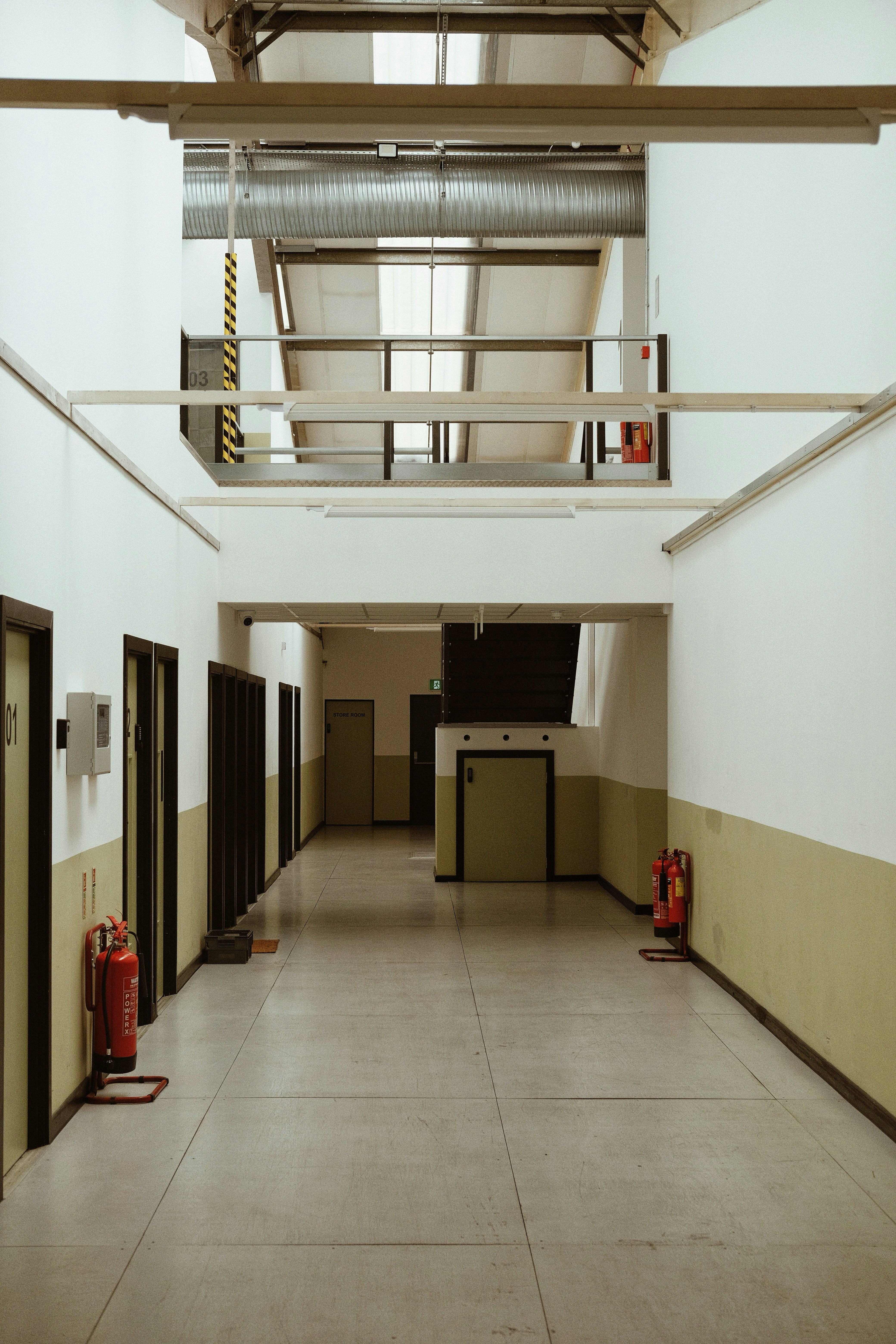 Industrial hallway with red fire extinguishers - Free Photo on Unsplash