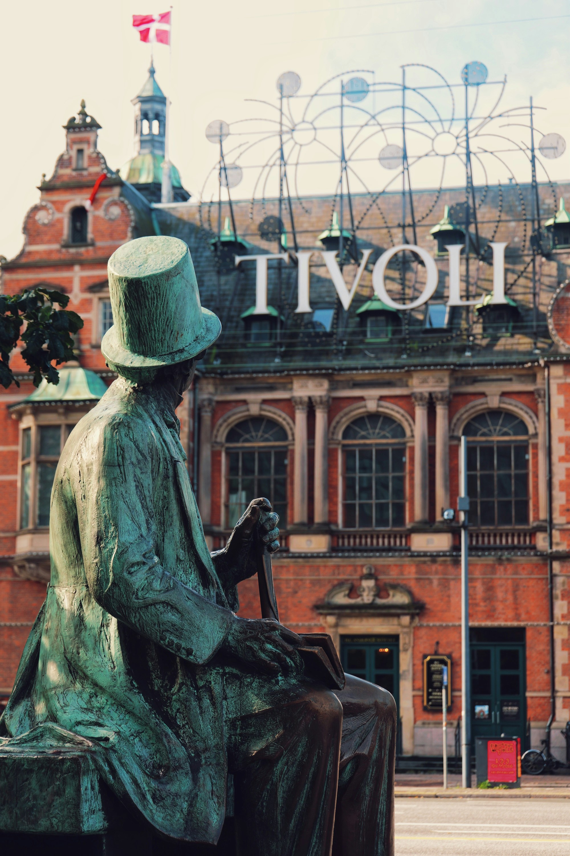 A bronze statue of Hans Christian Andersen in front of Tivoli Gardens in Copenhagen